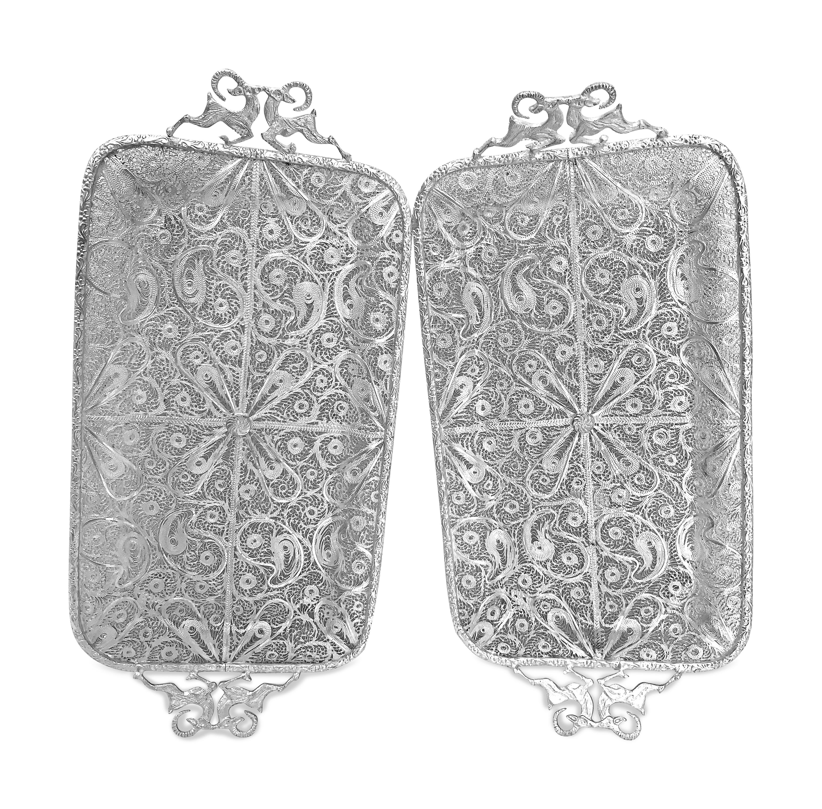 This beautiful pair has been made by hand and it is absolutely nice and pretty. The trays are persian silver filigree 0.99 karat which is almost pure silver . The handles are well designed with two goats on each side . The trays has four stands