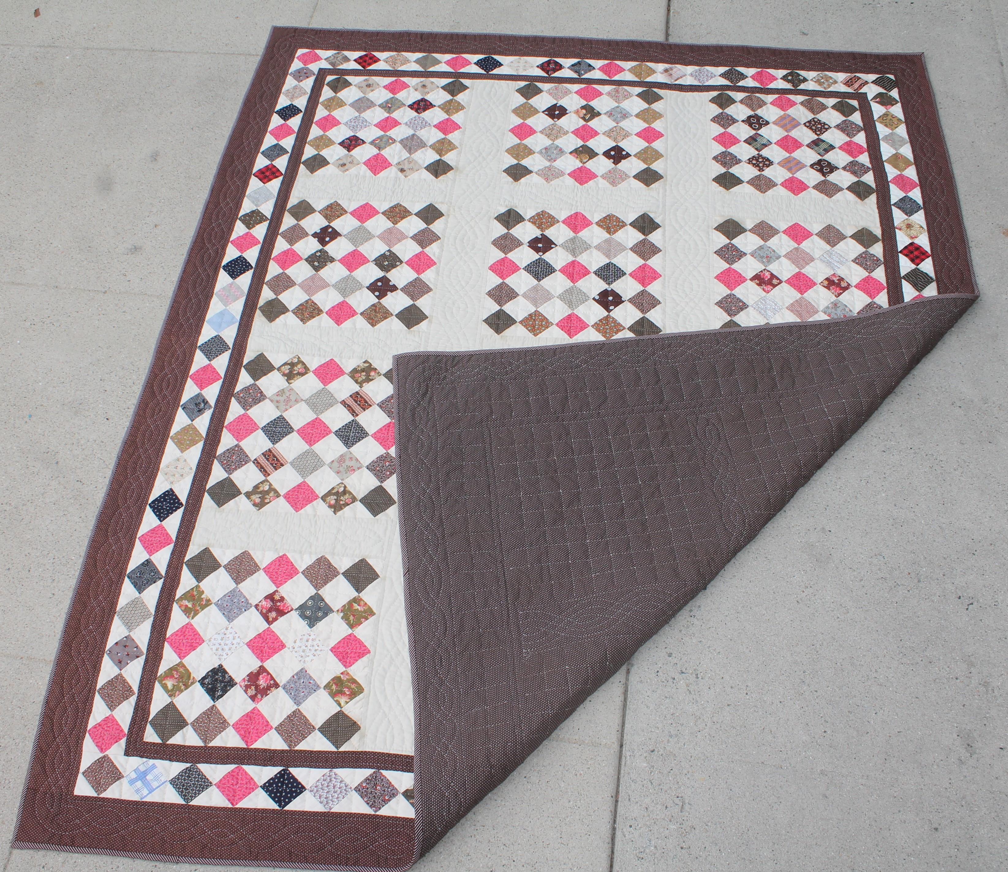 This folky contained one patch quilt is in mint condition and has a wonderful diamond block border.The condition is pristine.