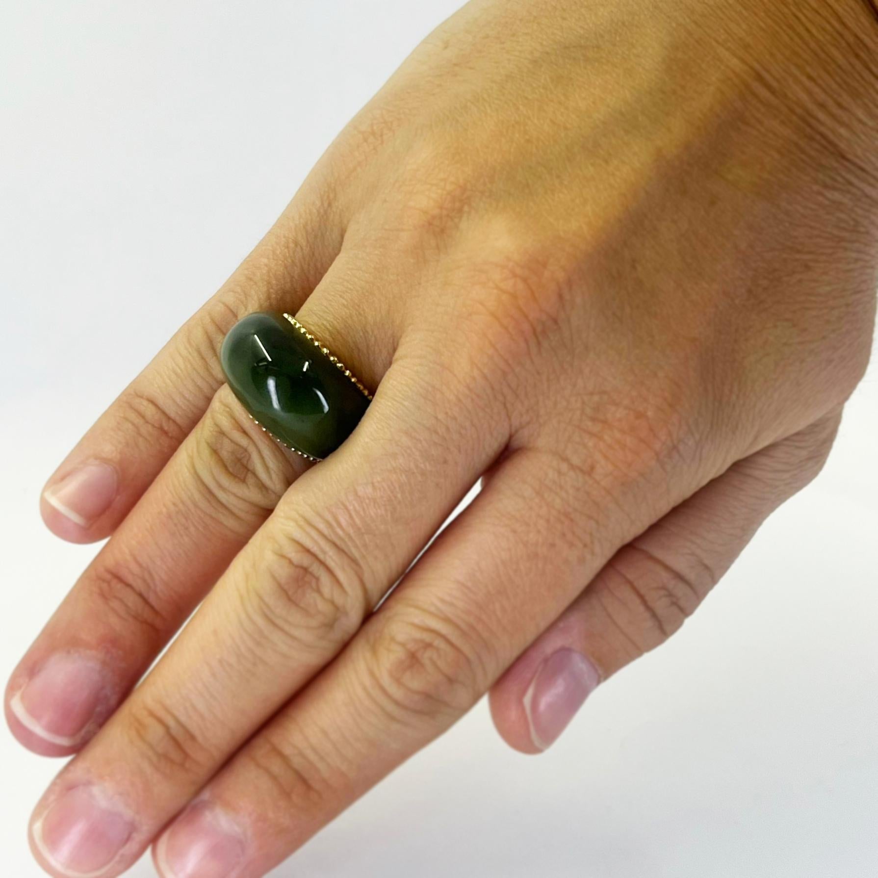 14 karat yellow gold carved green nephrite jade hololith dome ring featuring a beaded edge. Finger size 5.25. Cannot be sized. Finished weight is 12.1 grams.