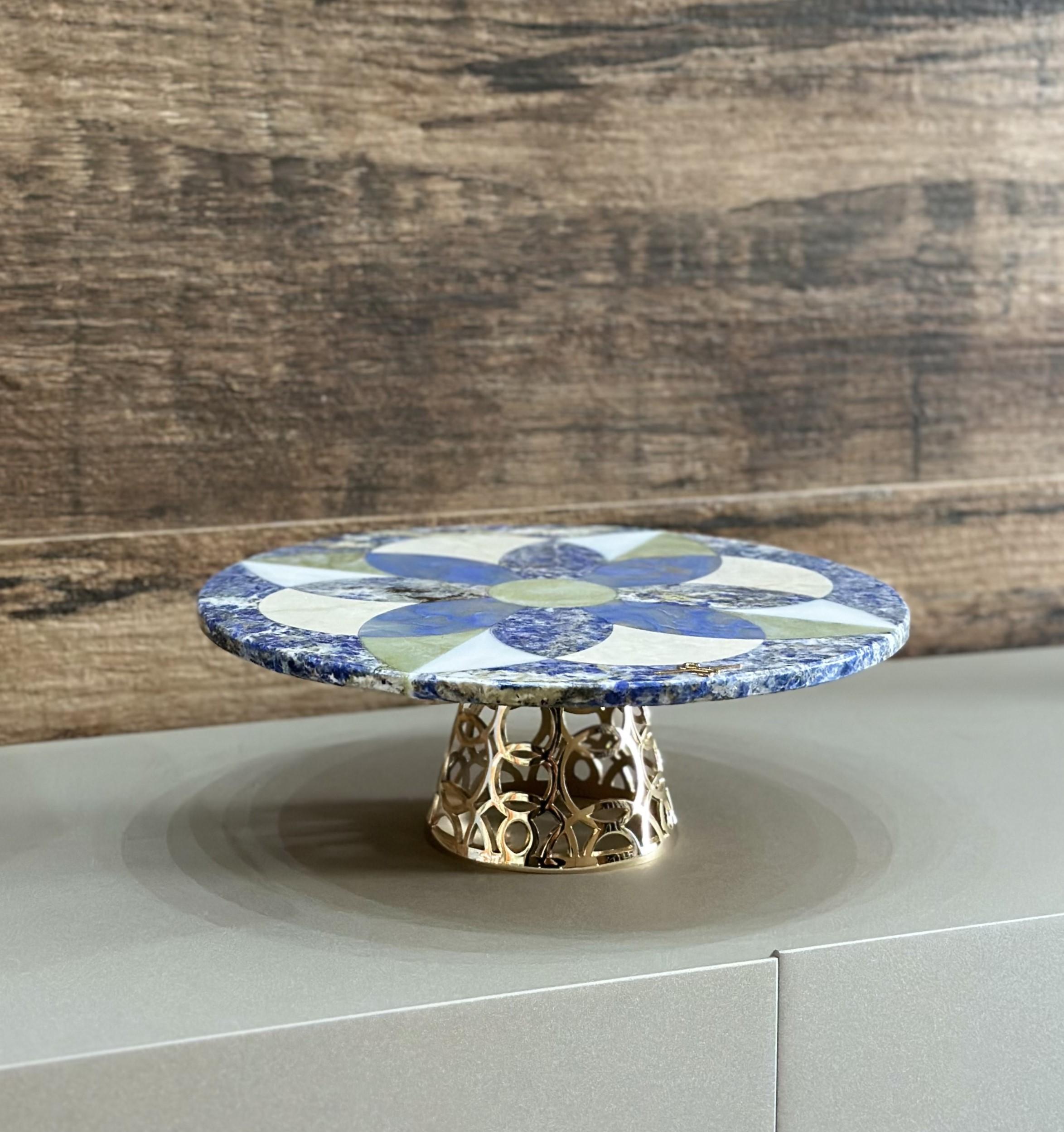 One plate Marble Inlay Cakestand by Euromarmi Store
Dimensions: D 33 x W 33 x H 11 cm
Materials: Sodalite, Azul Macaubas, Botticino, Verde Ming, Estemoz, 24K Gold-Plated.

Presented at Dubai Downtown Design, this refined cake stand is a true example