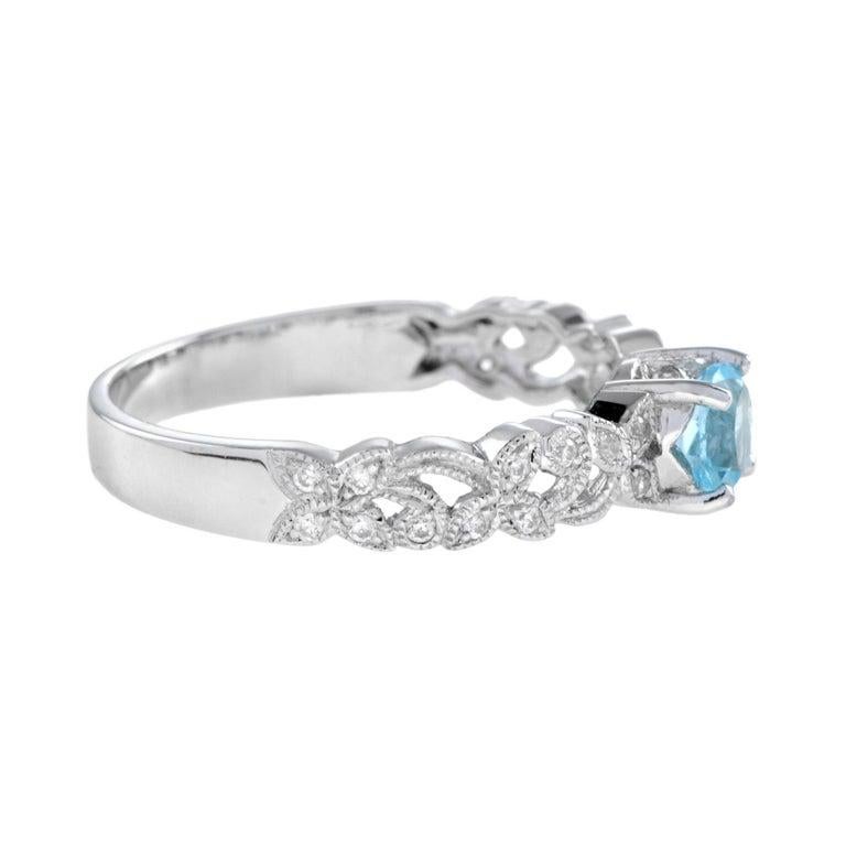 A ring with a unique, ethereal beauty, this romantic antique-inspired piece is the last word in feminine luxury. From the gorgeous 4.5 mm center blue topaz stone, set into this stunning ring with a classic prong setting, to the feminine and romantic