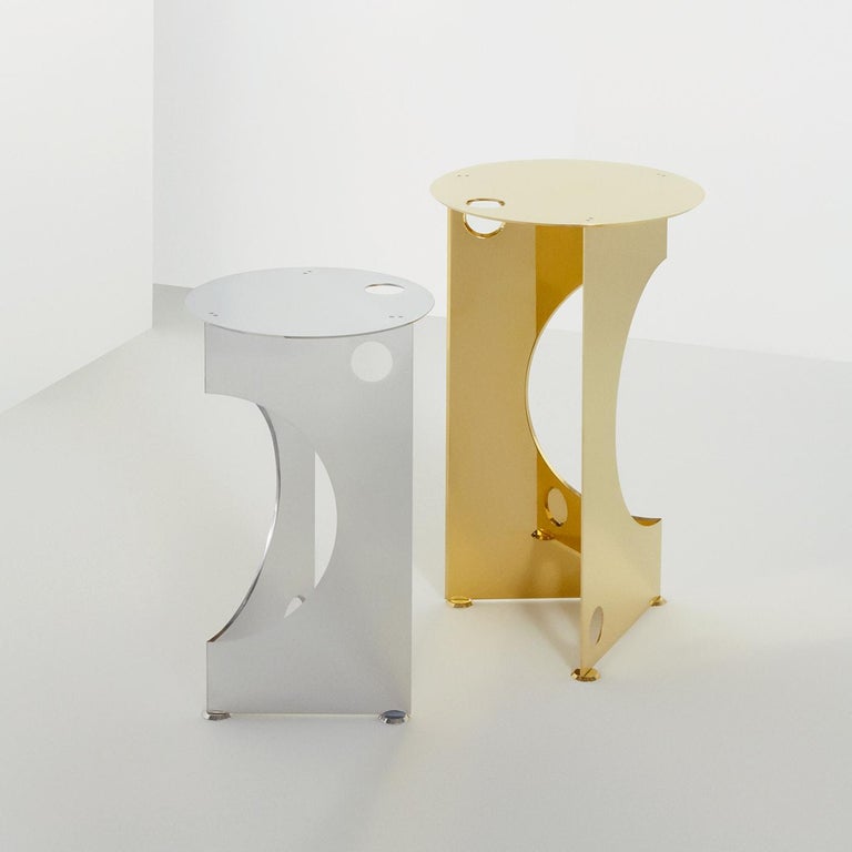 Inspired by pure geometric shapes, this side table displays Minimalist sophistication that makes it ideal for a modern interior. The round top is supported by a square base that is cutout by other circular elements for a dynamic effect. The feet are