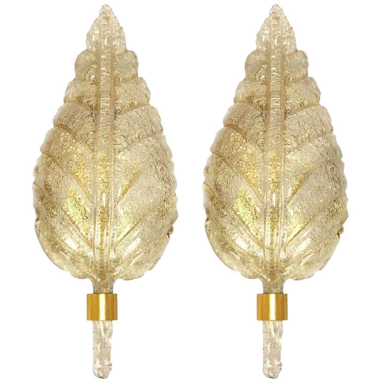 One of the four elegant and exquisite hand blown Murano glass Barovier & Toso wall sconces with special gold inclusions. Each light fixture consists one blown Murano glass leave. Mounted on a brass frame. The leaves refract light beautifully. The