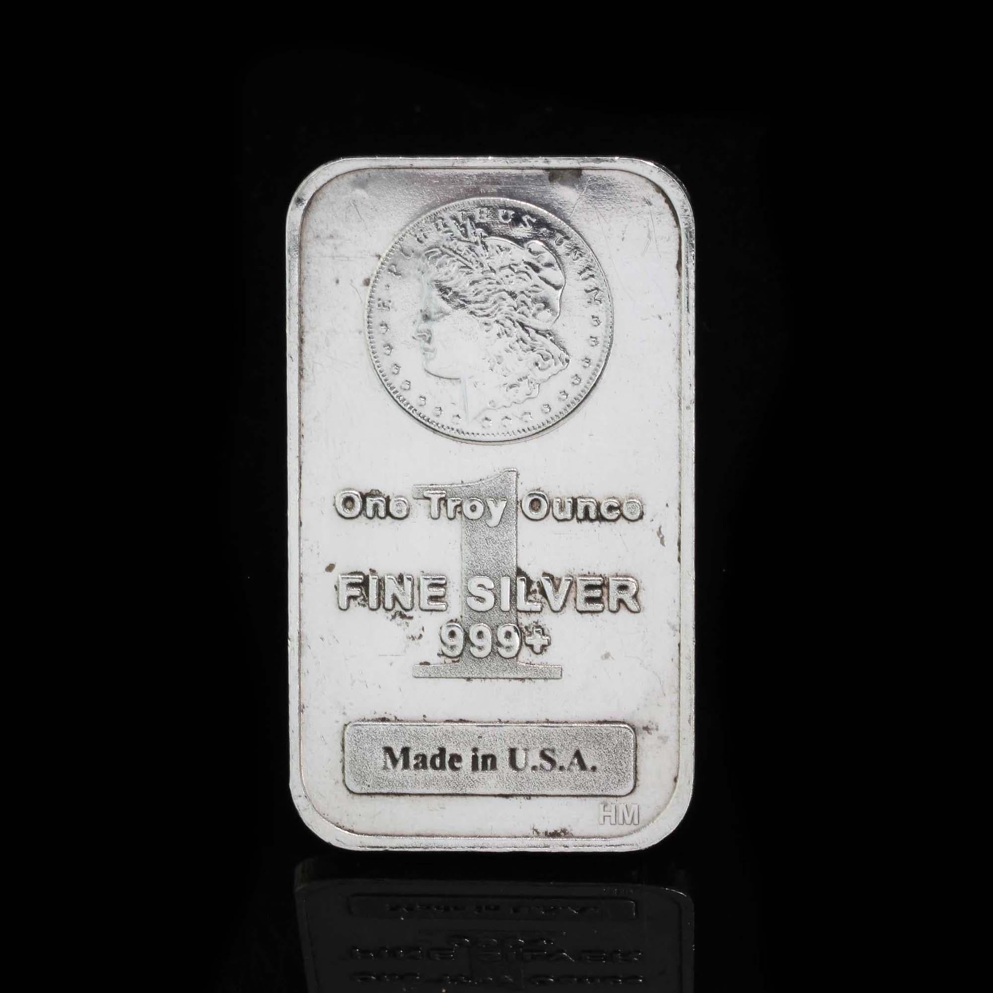 One Troy Ounce of fine silver 999+ 

The bar is stamped with the proud inscription Made in U.S.A. 
Morgan silver dollar right on the bar.
This lady of liberty profile within the dollar is offset by the silver bars stamps that denote its .999