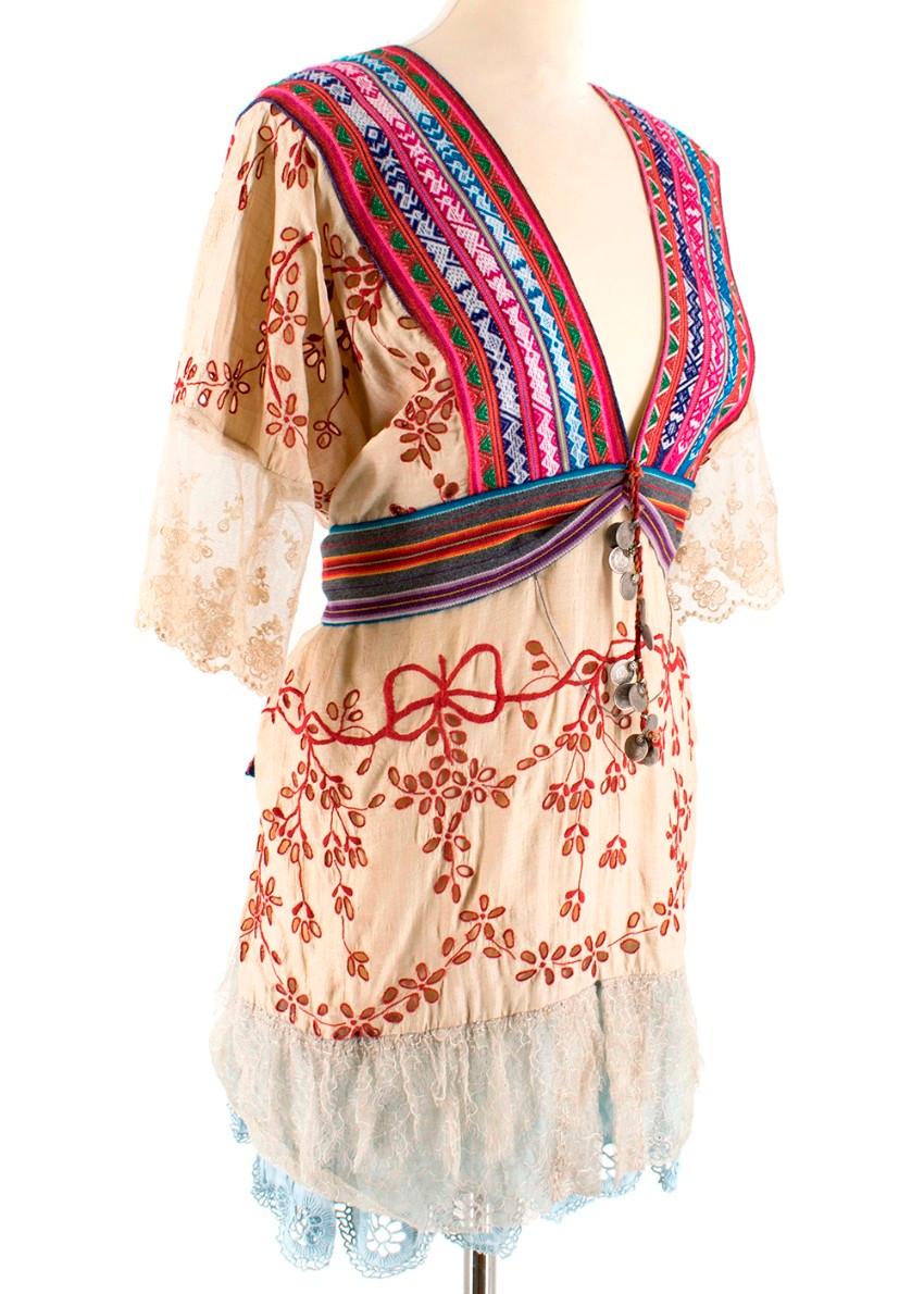One Vintage Bespoke Embroidered Bohemian Kaftan Blouse

- Low v-neck
- Wide embroidered neckline in multi-colour
- Red embroidered broderie
- Multicoloured striped tie back belt
- Rustic coin rope embellishment centre piece
- Loose silhouette
- Lace