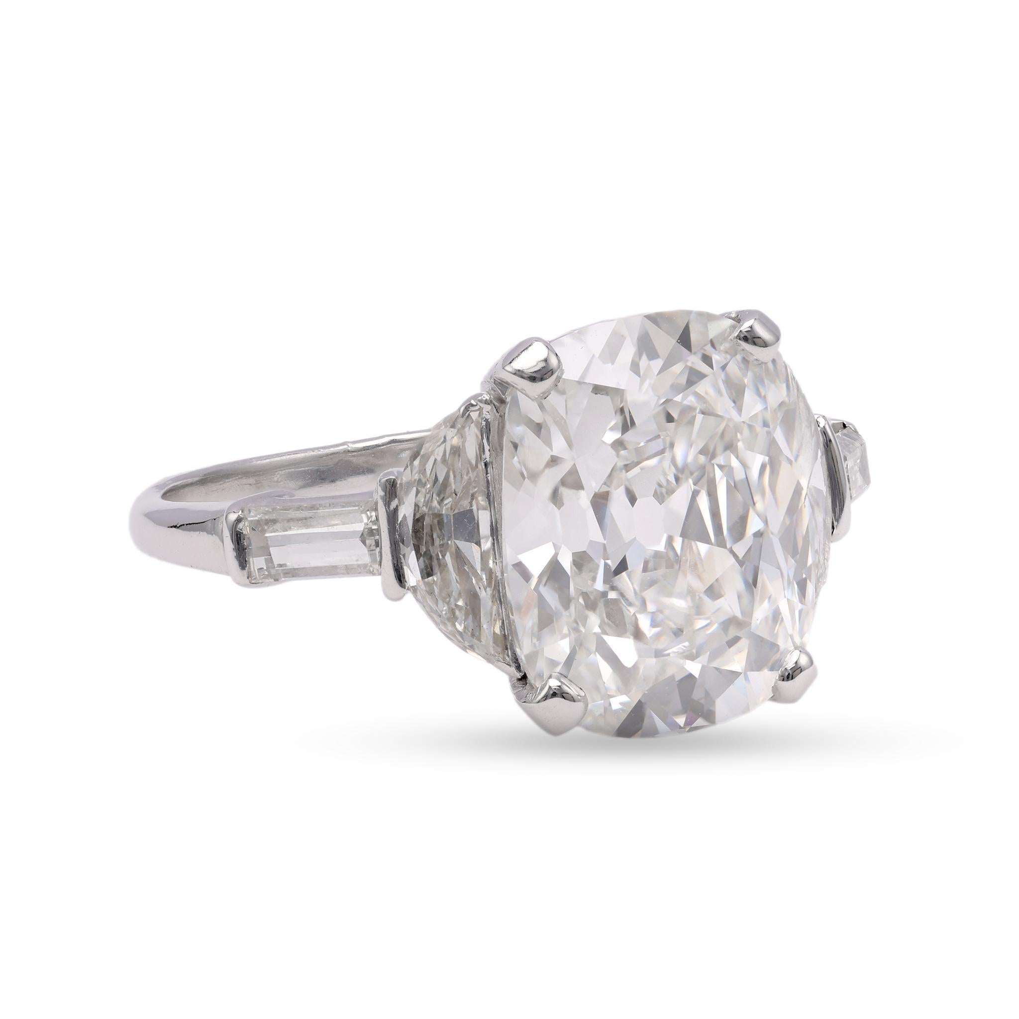 One Vintage GIA 4.52 Carat Antique Cushion Cut Diamond Platinum Ring. Featuring one GIA cushion modified brilliant cut diamond of 4.52 carats, accompanied by GIA #2239209305 stating the diamond is F color, VS2 clarity. Accented by two half moon and
