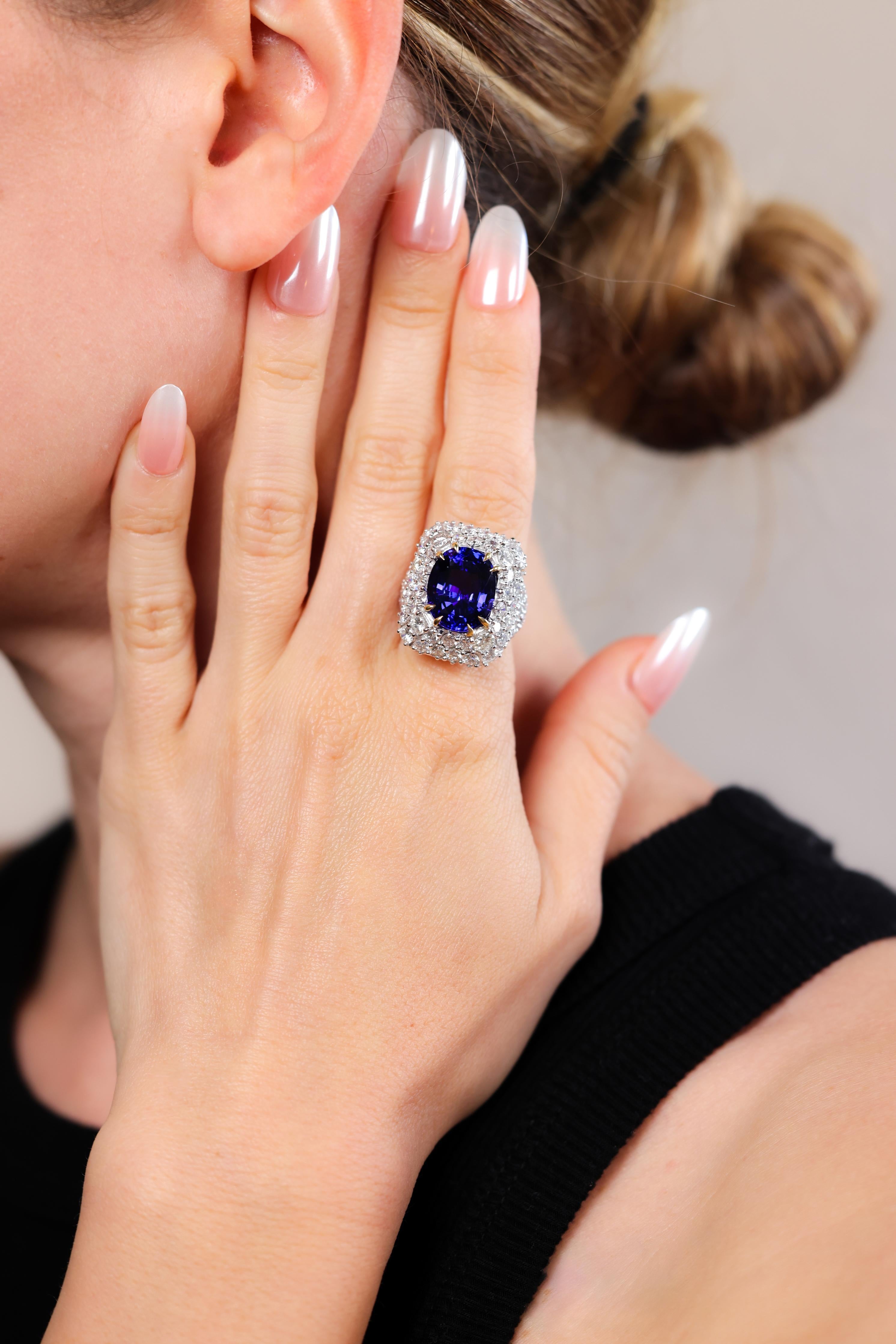 One Vintage Tanzanite Diamond Palladium Ring. Featuring one oval mixed cut tanzanite of 10.54 carats. Accented by numerous round brilliant cut diamonds with a total weight of approximately 6.65 carats, graded near-colorless, VS clarity. Crafted in