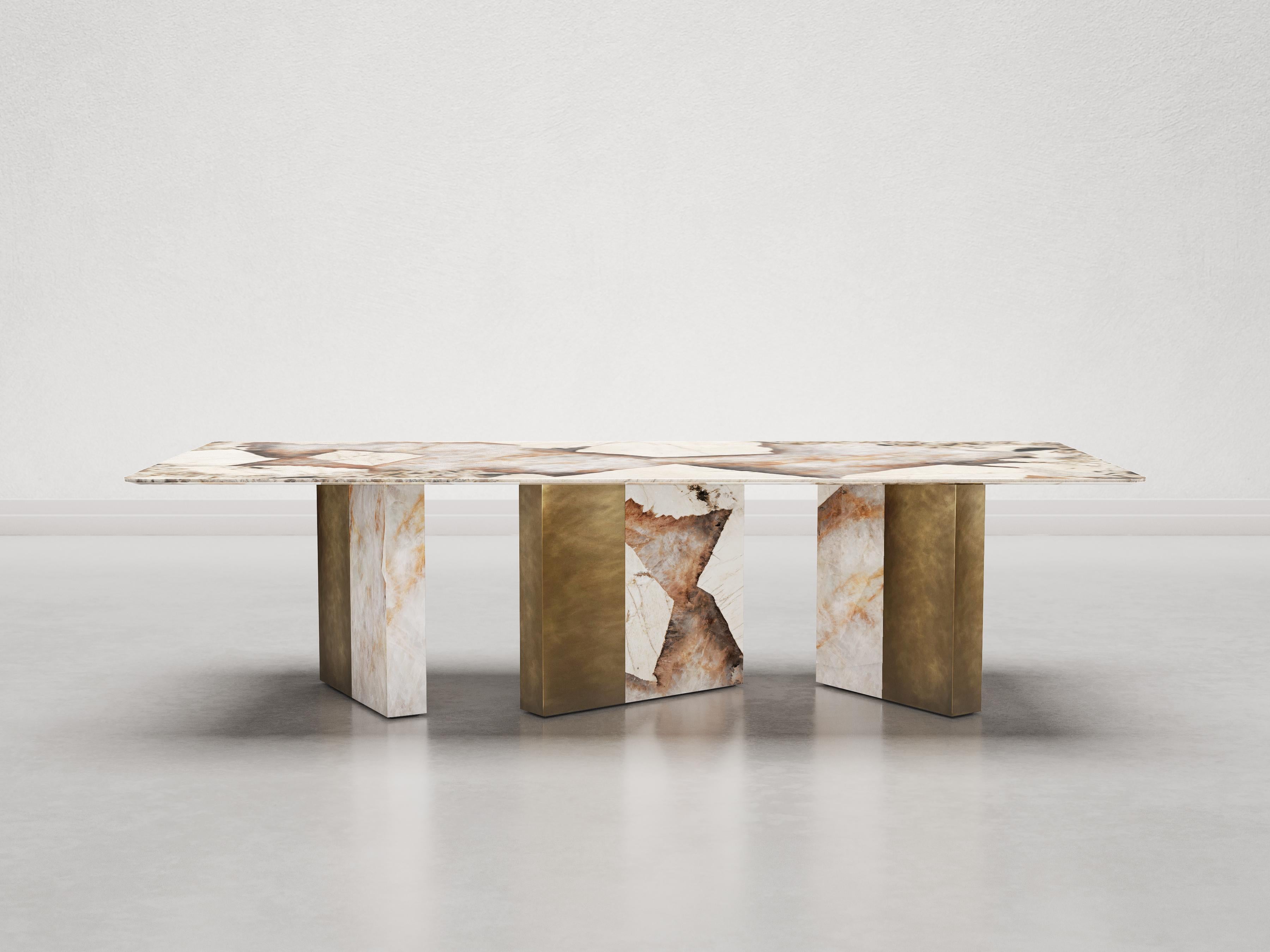 One Way Or Another dining table is composed of a top in Patagonia marble with diamond-cut on the lower edge, reinforced by a metal support fixed to three asymmetrical legs. 
Each leg is covered with a different combination of Patagonia marble slabs
