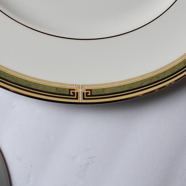 One place setting of Wedgwood Oberon table settings. This set includes one tea saucer, small saucer, small plate, and dinner plate. Embellished in green, red and gold, this would be the perfect place setting to either add to an existing set of china
