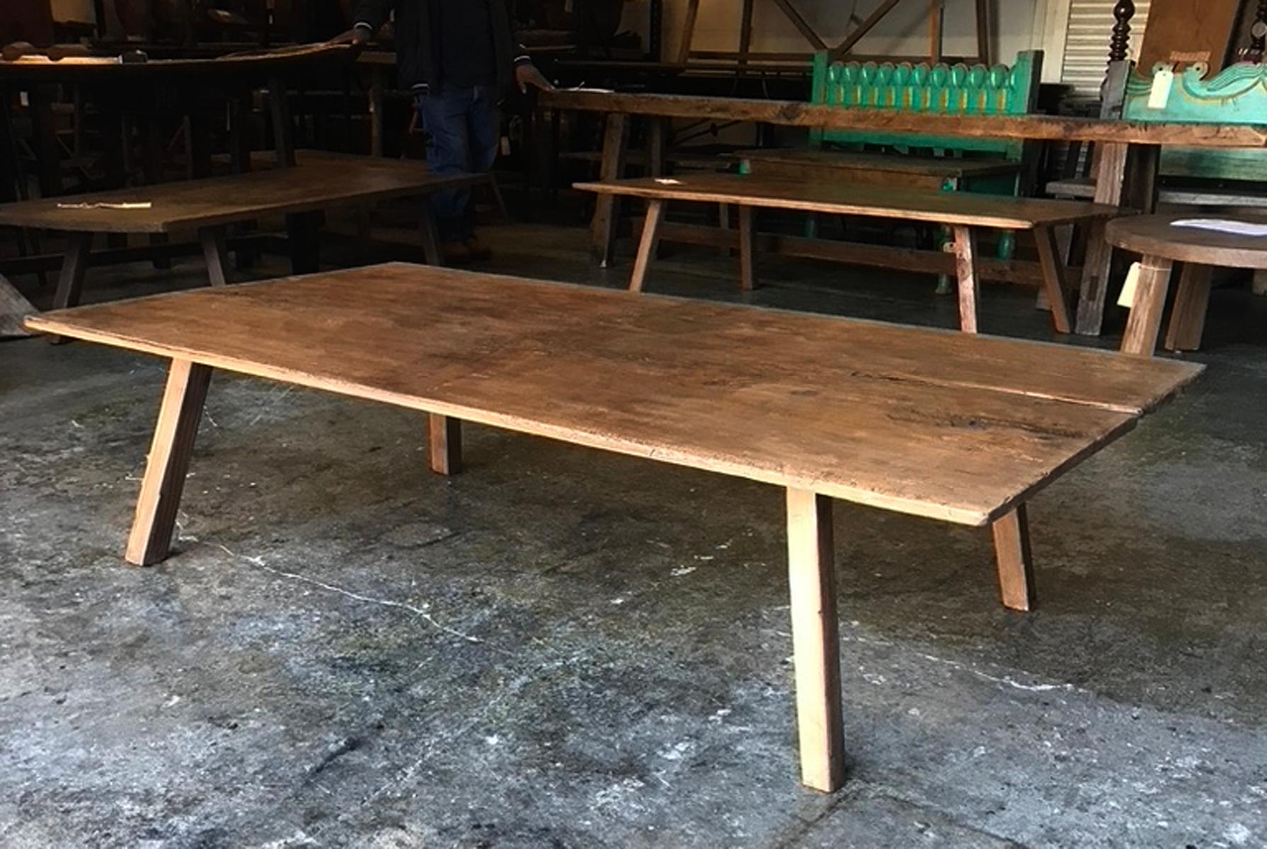 This coffee table consists of a beautiful, old, hand-hewn top on new legs, finished to match the top. The wood has beautiful, age appropriate wear in a range of colors, all naturally distressed. This one wide piece of wood was at some part used on