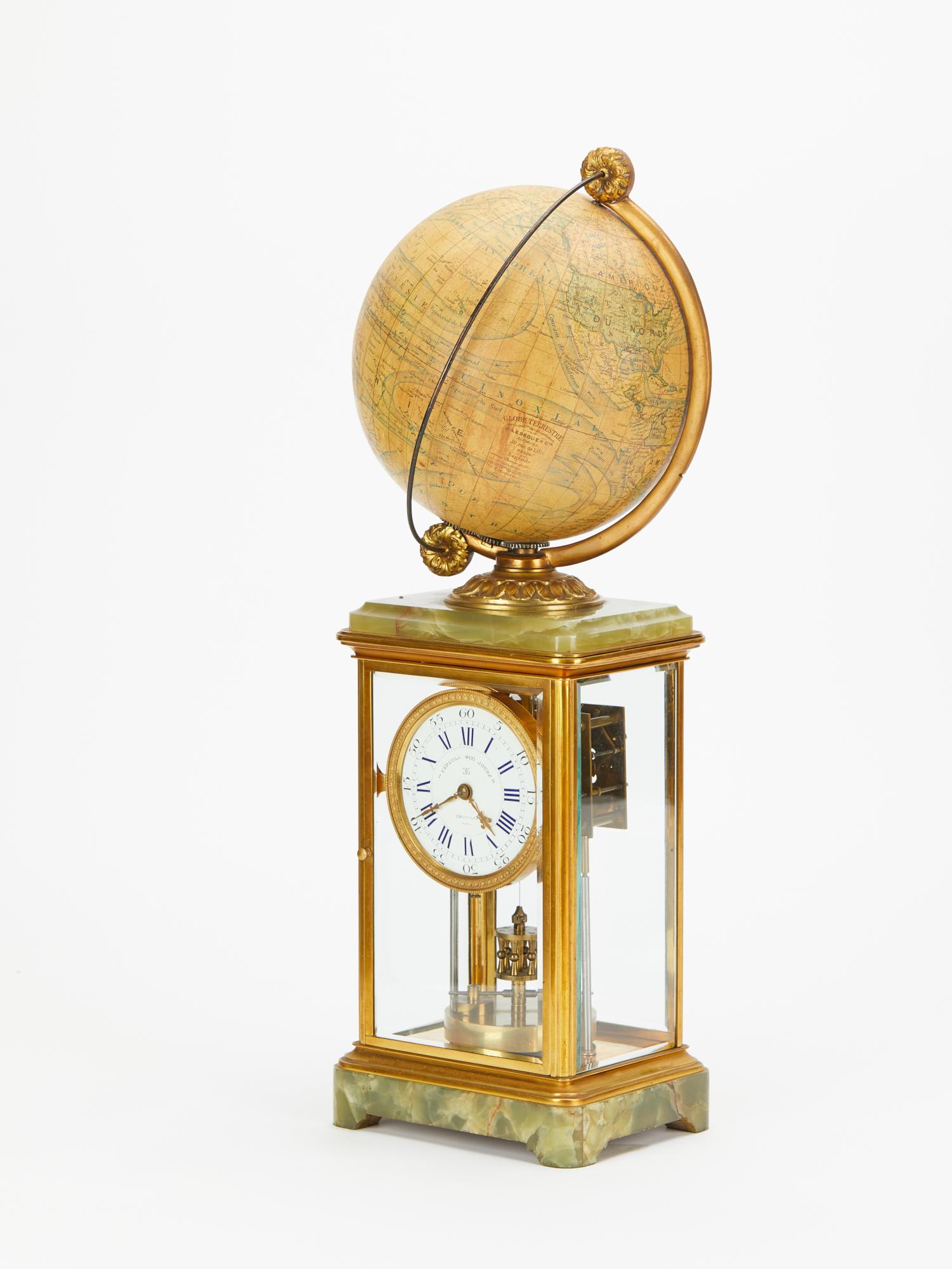 An interesting and unusual good 4 glass YEAR RUNNING mantel clock with rotating celestial globe on top.The case with onyx marble together with the gilded brass vitrine shows the non stop rotating pendulum. Signature GRIVILAS