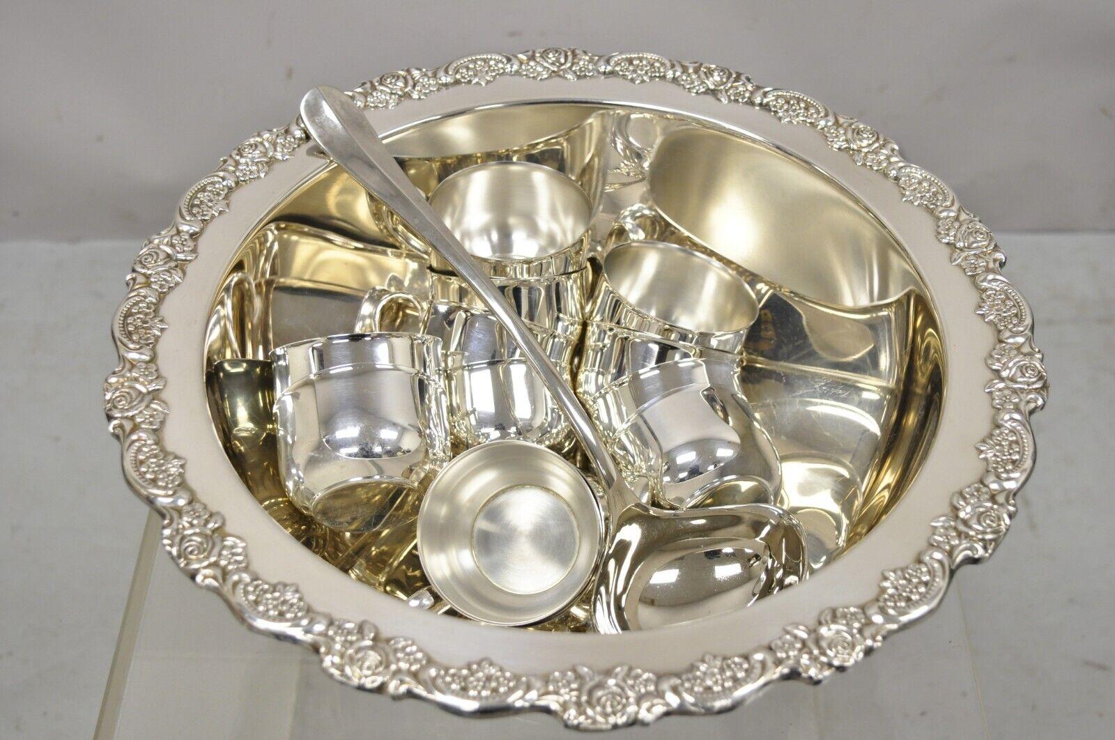 Oneida silver plated punch bowl set with 12 cups and ladle. Item features (12) cups, (1) punch bowl, (1) ladle. Circa Late 20th Century. Measurements: 7