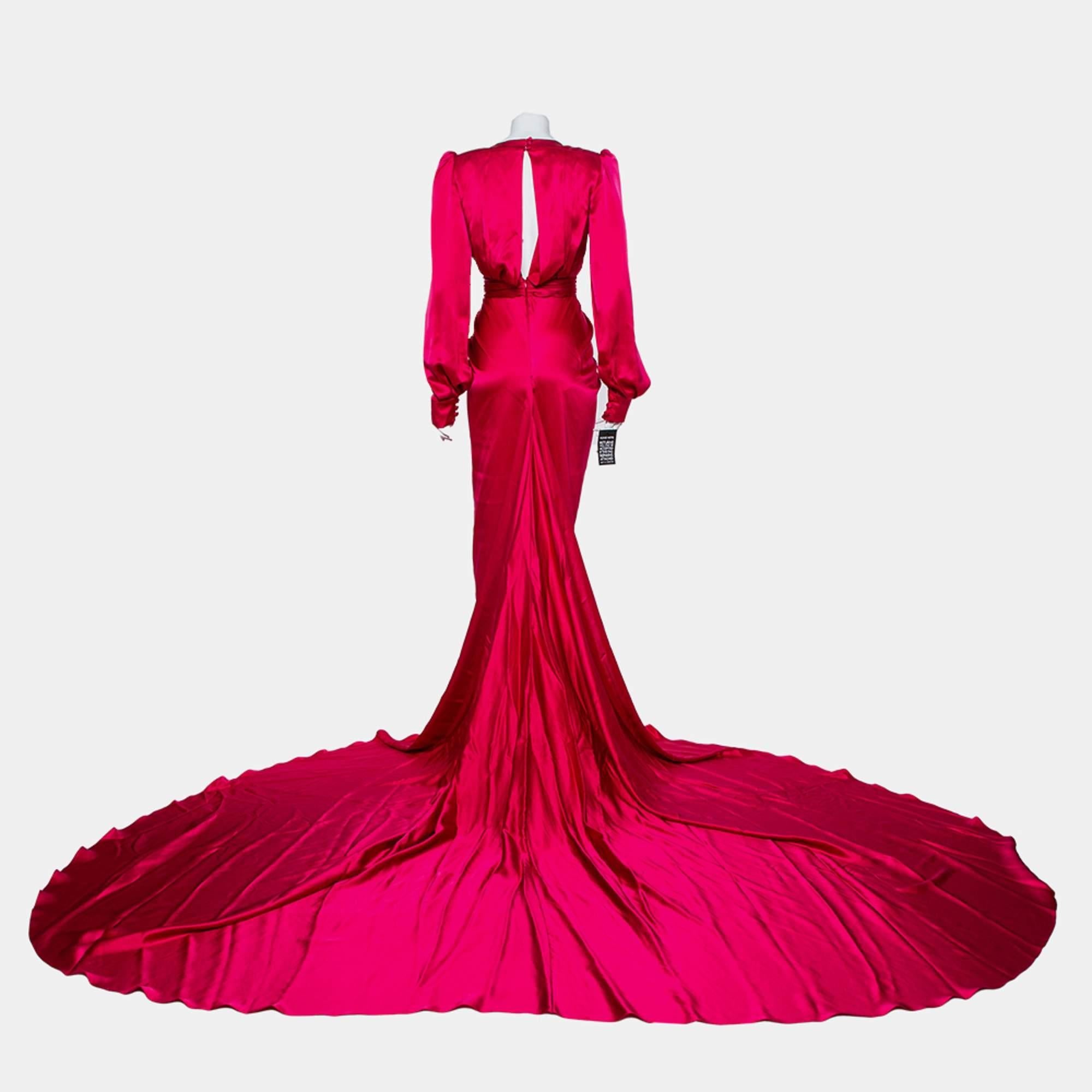 Create the most stunning red carpet looks wearing this gorgeous Ong-Oaj Pairam Angelica gown that is fit for a diva. Constructed in Fuschia pink satin fabric, this gown features a pleated silhouette with waist belt detailing, a plunging neckline,