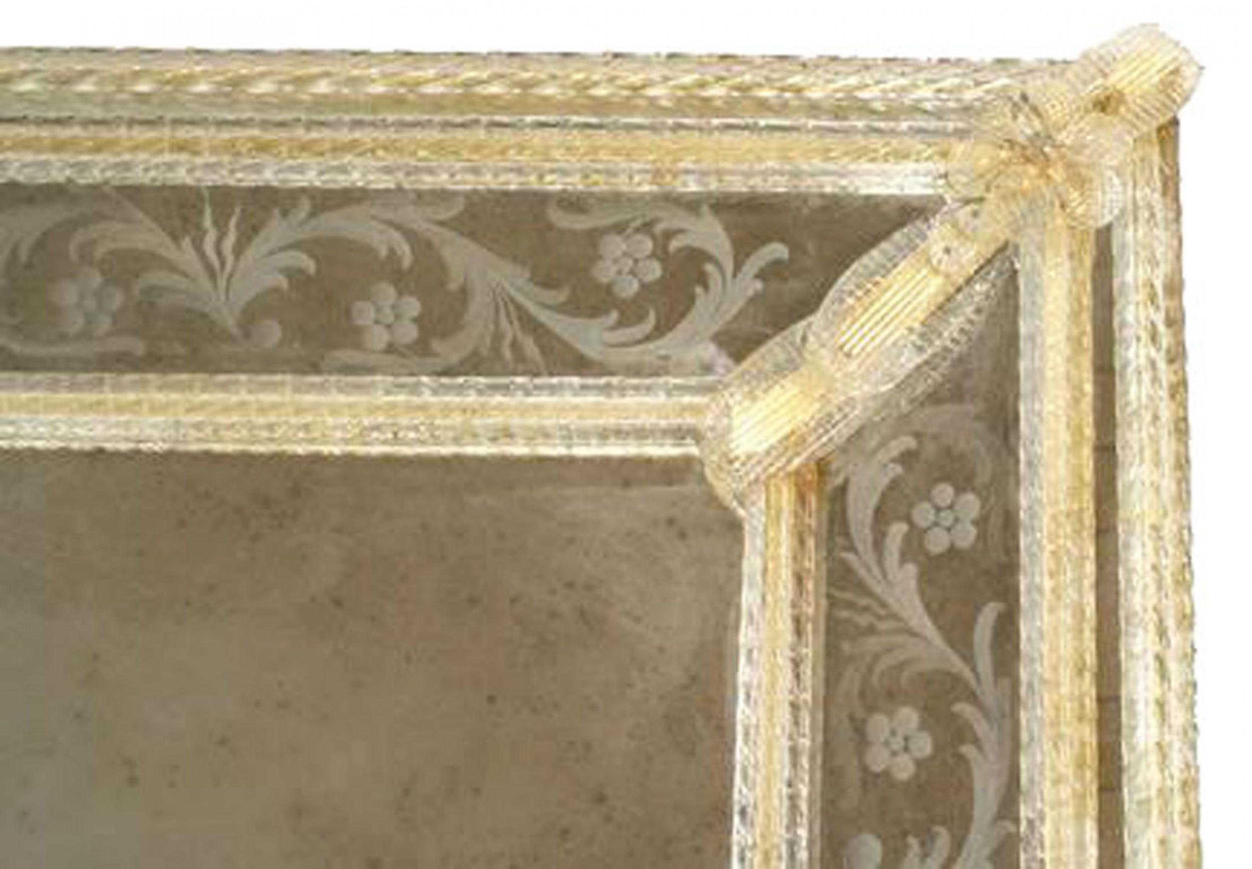 Italian Venetian Murano wall mirror with etched floral and scroll design border, applied gold dusted glass leaves, and spindle trim. (ONGARO E FUGA).