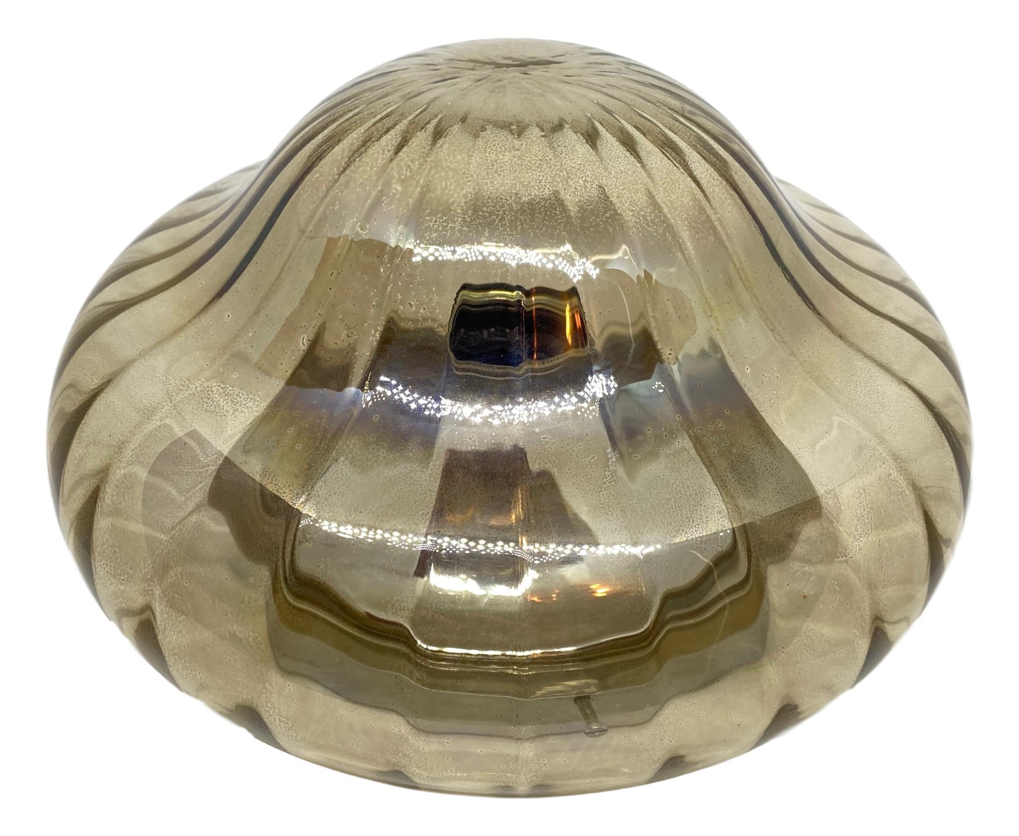 A petite gorgeous glass flush mount. It can be used also as a sconce. The light fixture requires one European E27 bulb, up to 60 watts. Iridescent glass, mounted on a chrome base.