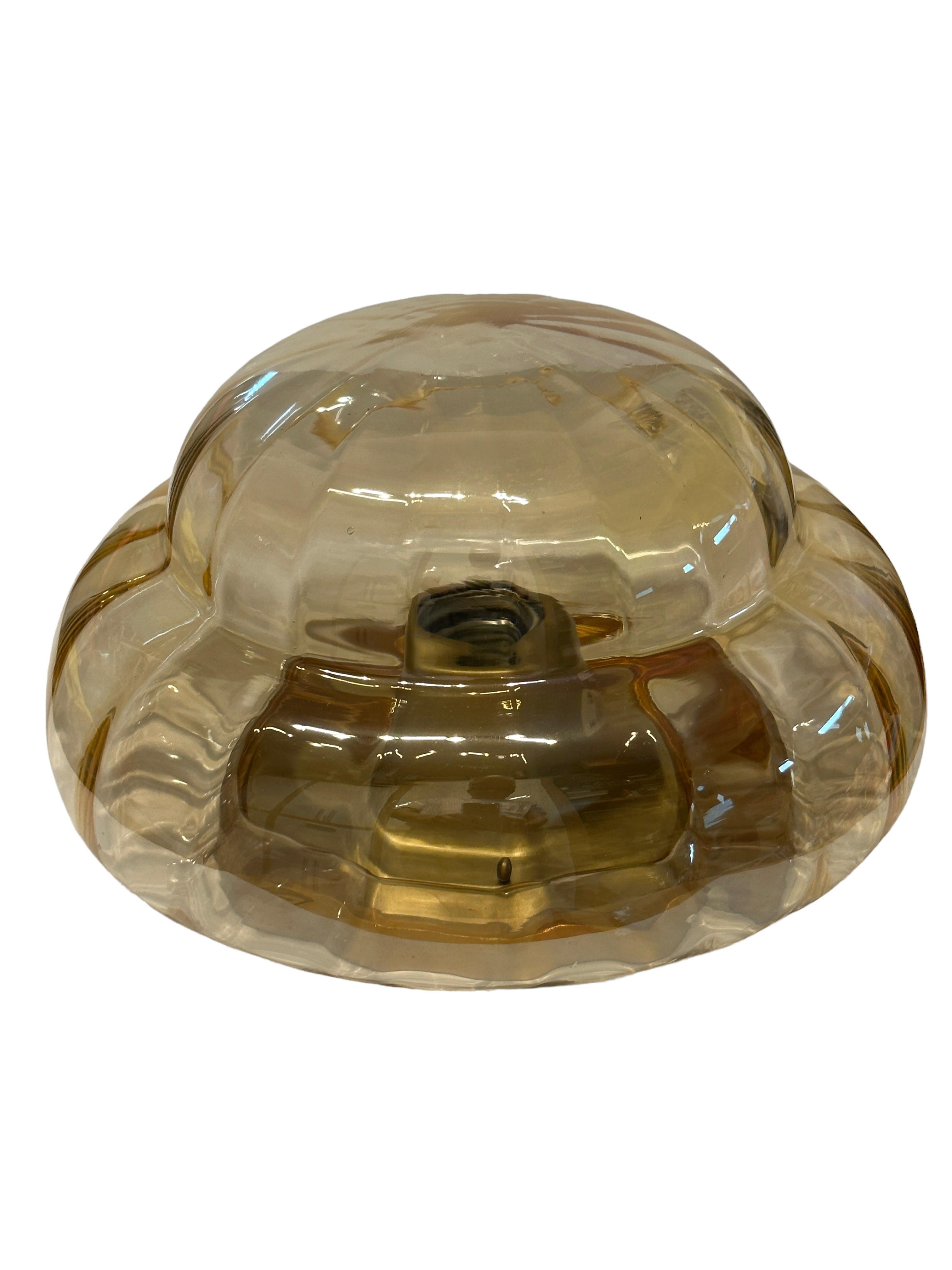 A petite gorgeous glass flush mount. It can be used also as a wall light. The light fixture requires one European E27 bulb, up to 60 watts. Amber smoked glass, mounted on a gilded base. A nice addition to any room. Found at an estate sale in Vienna,