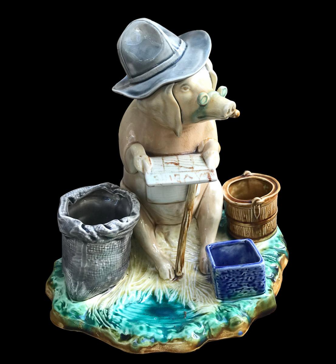 Onnaing style barbotine tobacco box representing a sitting pig with a cane, wearing glasses and a blue hat, smoking and reading a French newspaper called 