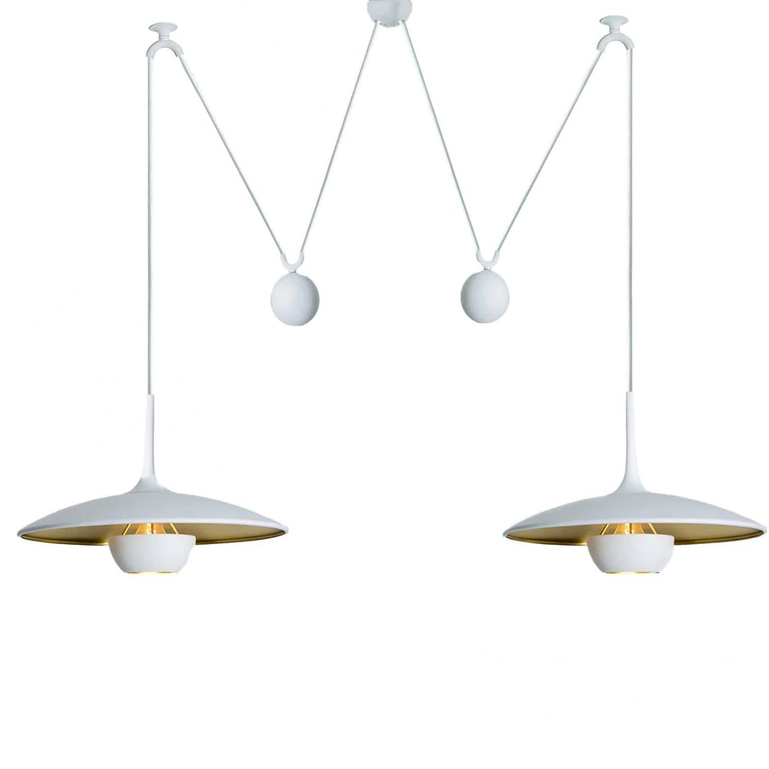Fantastic pendant light Onos-40 Double Pull  by Florian Schulz, Germany, Europe. Design period: 1970-1979, production period: 2022.

Two white lackered brass polished pendants suspended with their own brass ball counter balance. One canopy supports