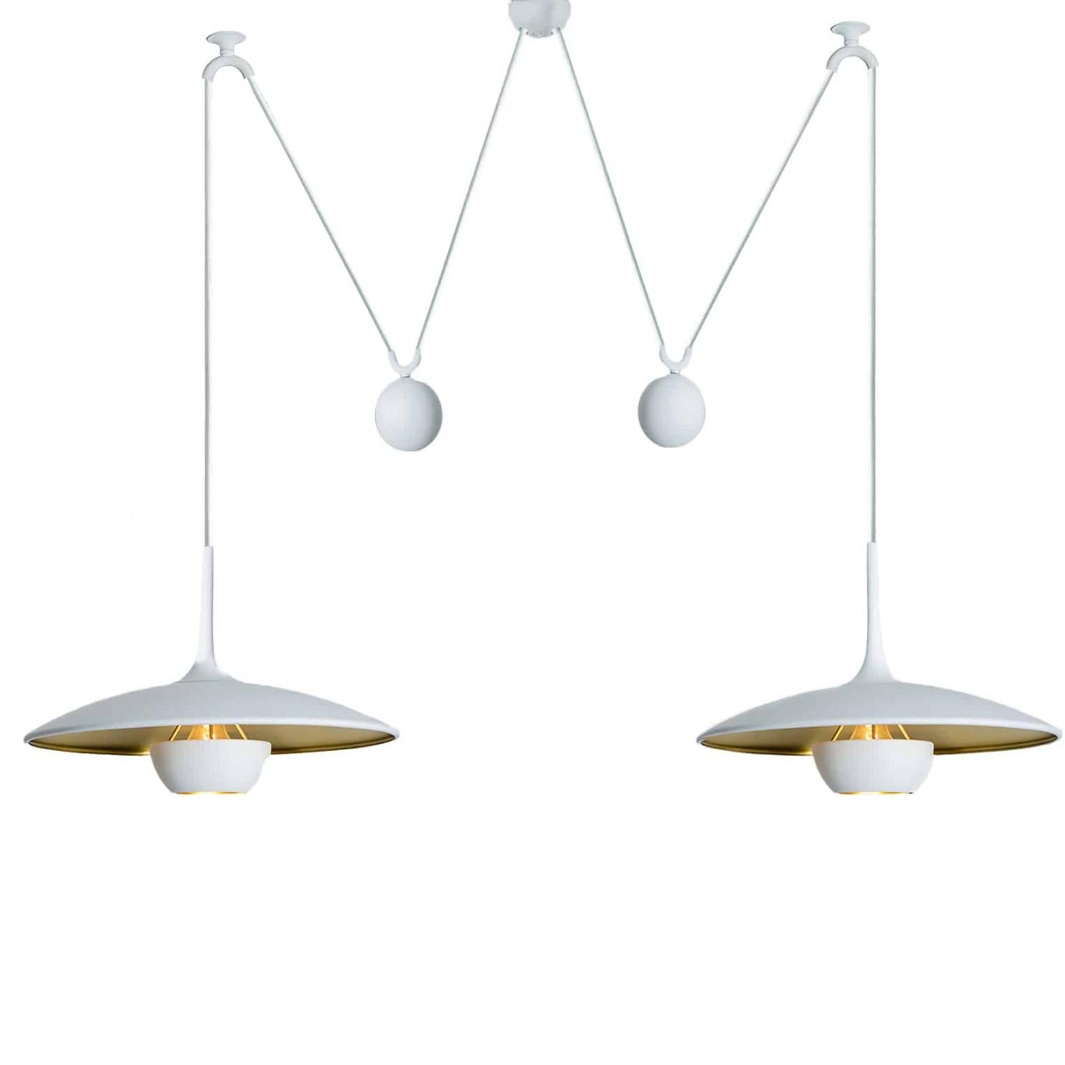 Fantastic pendant light Onos-40 Double Pull  by Florian Schulz, Germany, Europe. Design period: 1970-1979, production period: 2022.

Two white lackered brass polished pendants suspended with their own brass ball counter balance. One canopy supports