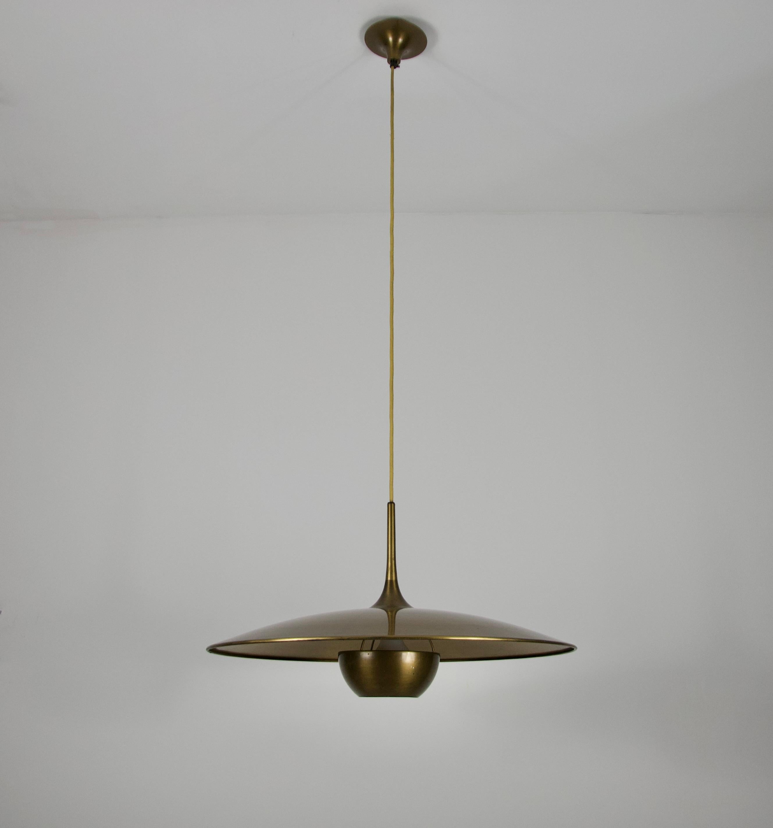 Designed by Florian Schulz and crafted in Germany in the 1970s, this pendant light captivates with its elegant and functional design. Its sleek, minimalist aesthetic reflects the era's focus on clean lines and purposeful design. This pendant is a