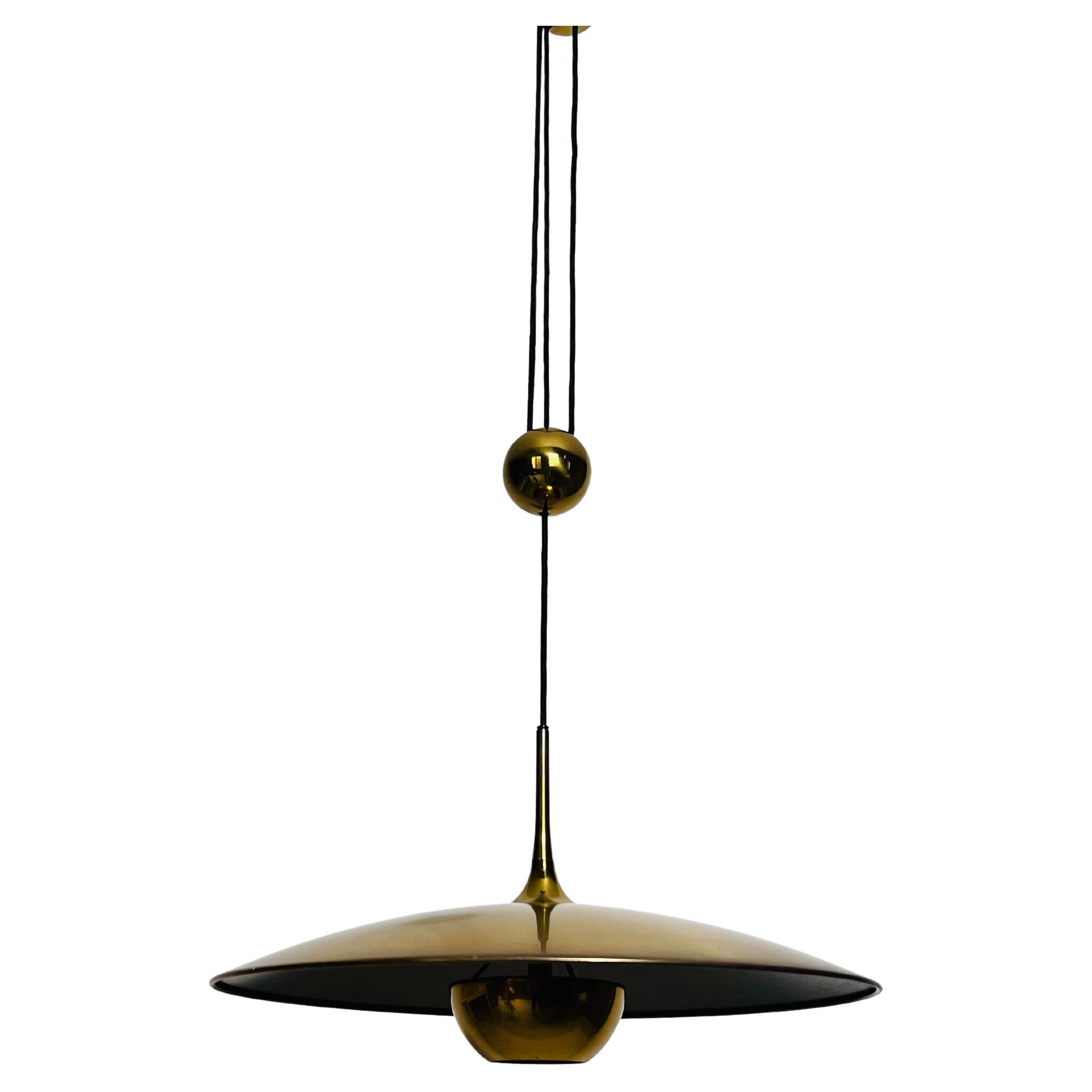 Designed by Florian Schulz and crafted in Germany in the 1970s, this counter balance pendant light captivates with its elegant and functional design. Featuring a distinctive counterweight mechanism, the pendant allows for easy height adjustment,