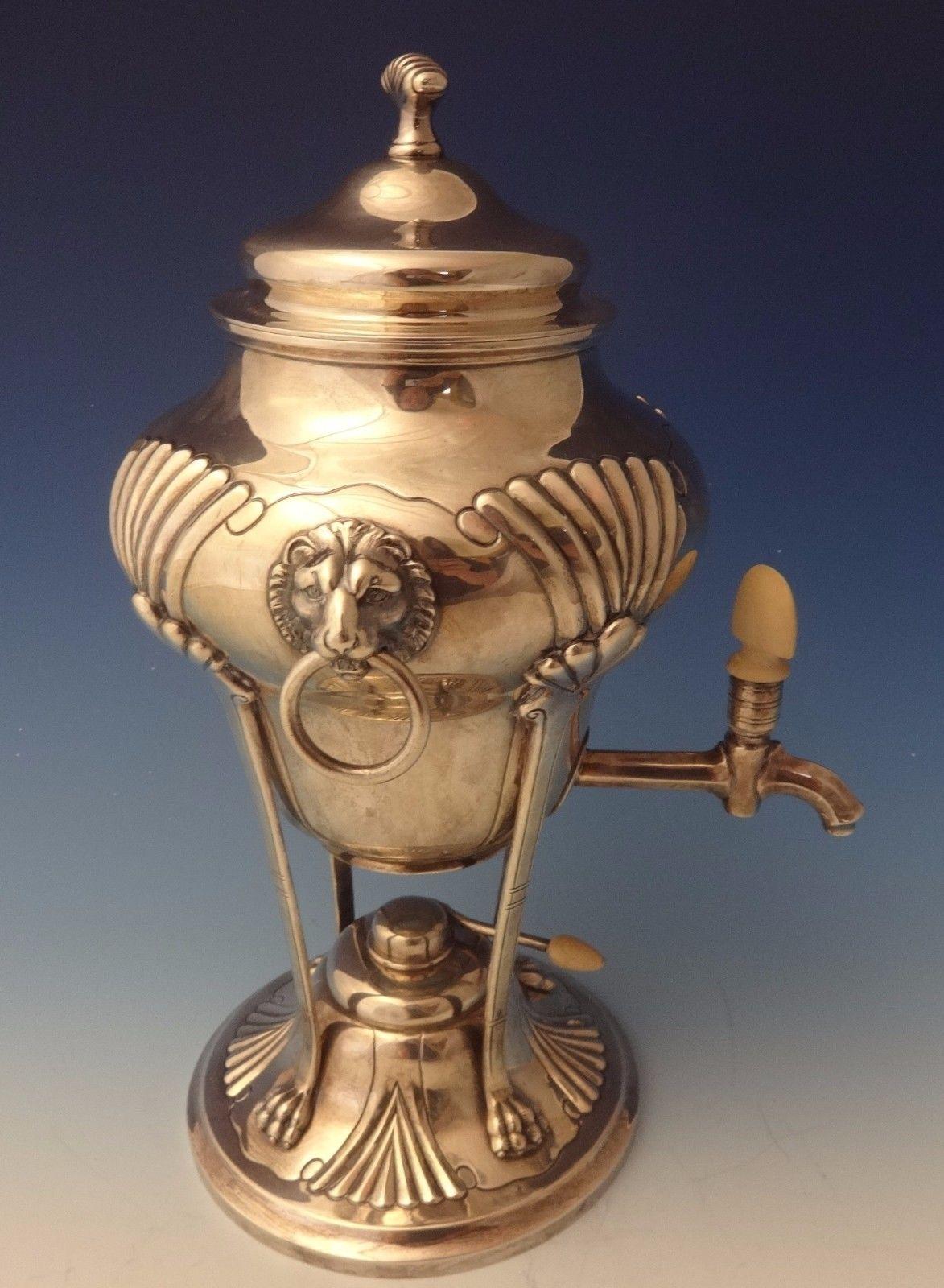 Onslow by Tuttle
This rare Onslow by Tuttle sterling hot water urn/samovar has superb applied 3-D lion heads and lion paws. The spigot and burner handle have finials. The piece has a DRD monogram, and it has the Harry Truman HT date mark. It dates