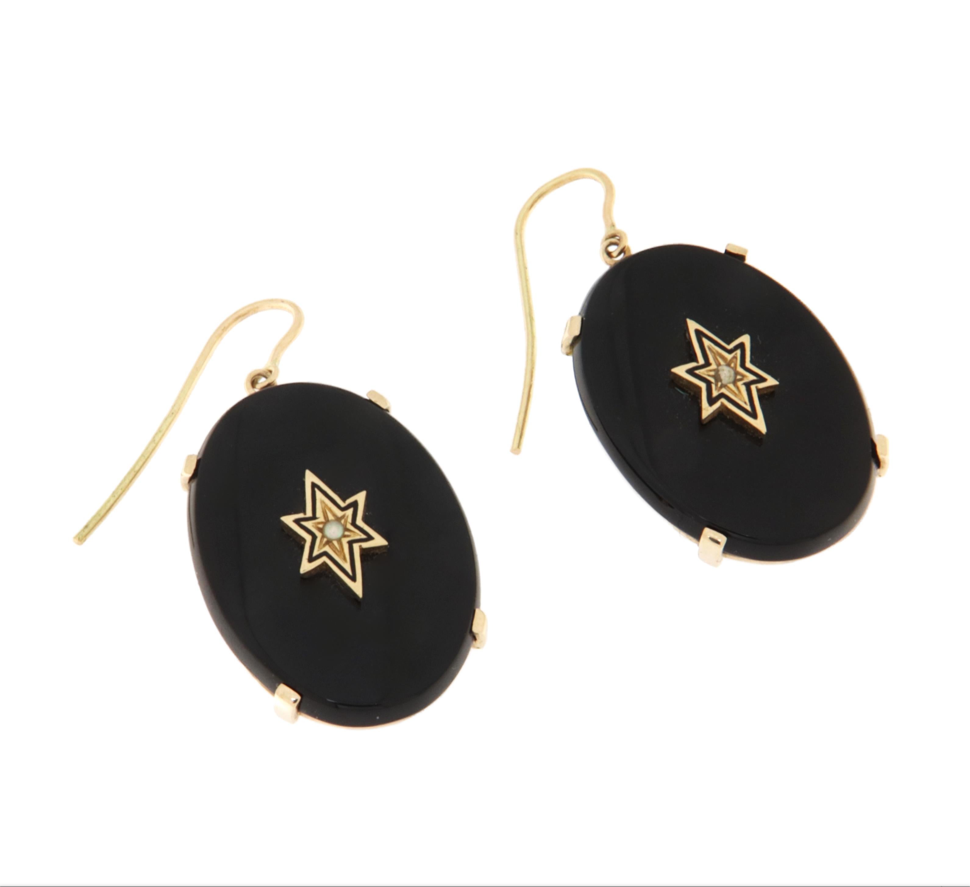 Entdecken Sie die zeitlose Eleganz dieser raffinierten Ohrringe aus 14-karätigem Gelbgold mit einer ovalen Platte aus schwarzem Onyx und einem zarten, erhabenen Sternmotiv.

Der natürliche Onyx mit seinem tiefschwarzen Farbton verleiht diesen