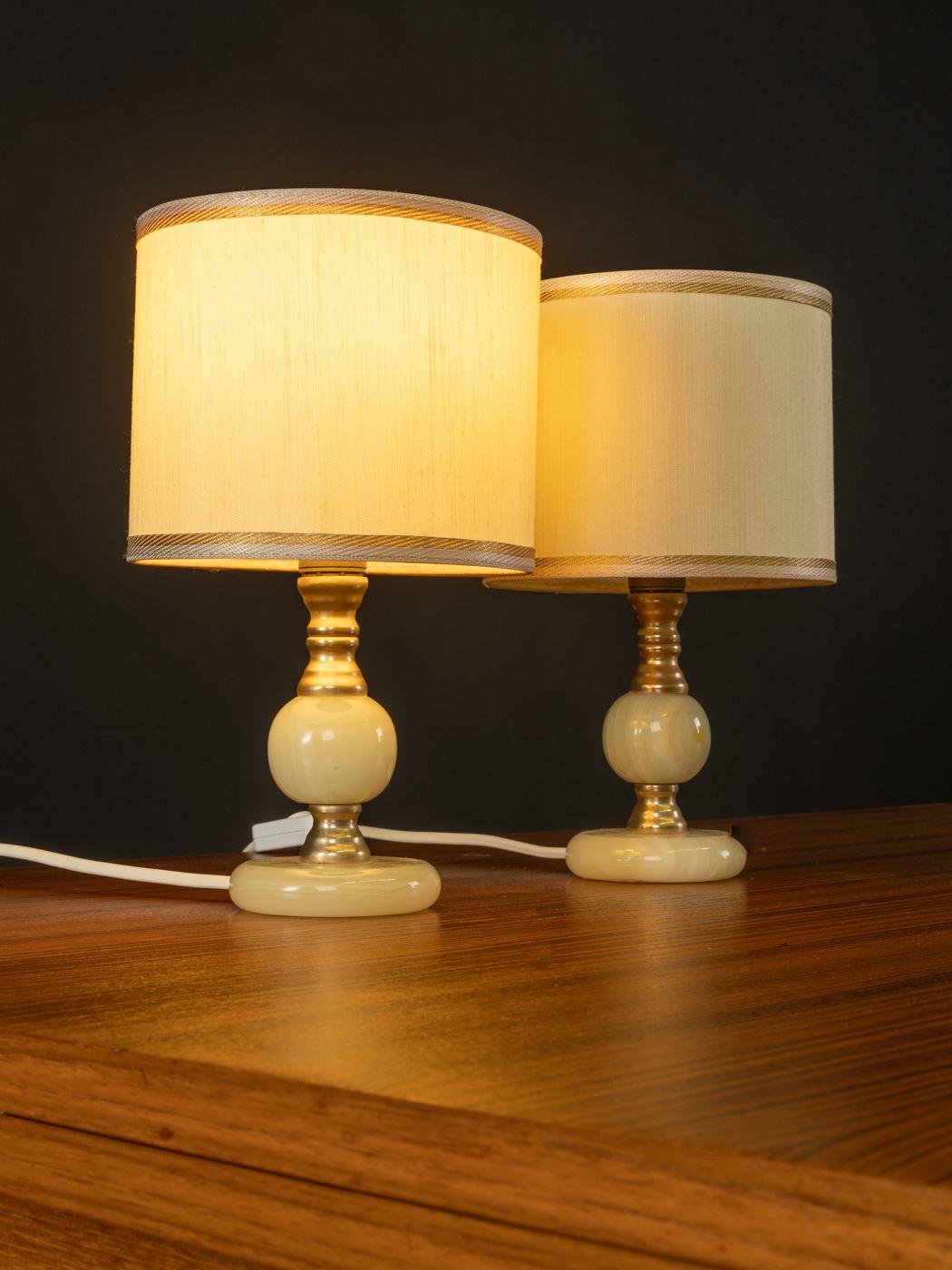 Beautiful bedside lamps from the 1960s. Cream white lampshade with onyxmarble and brass base. Made in Germany.