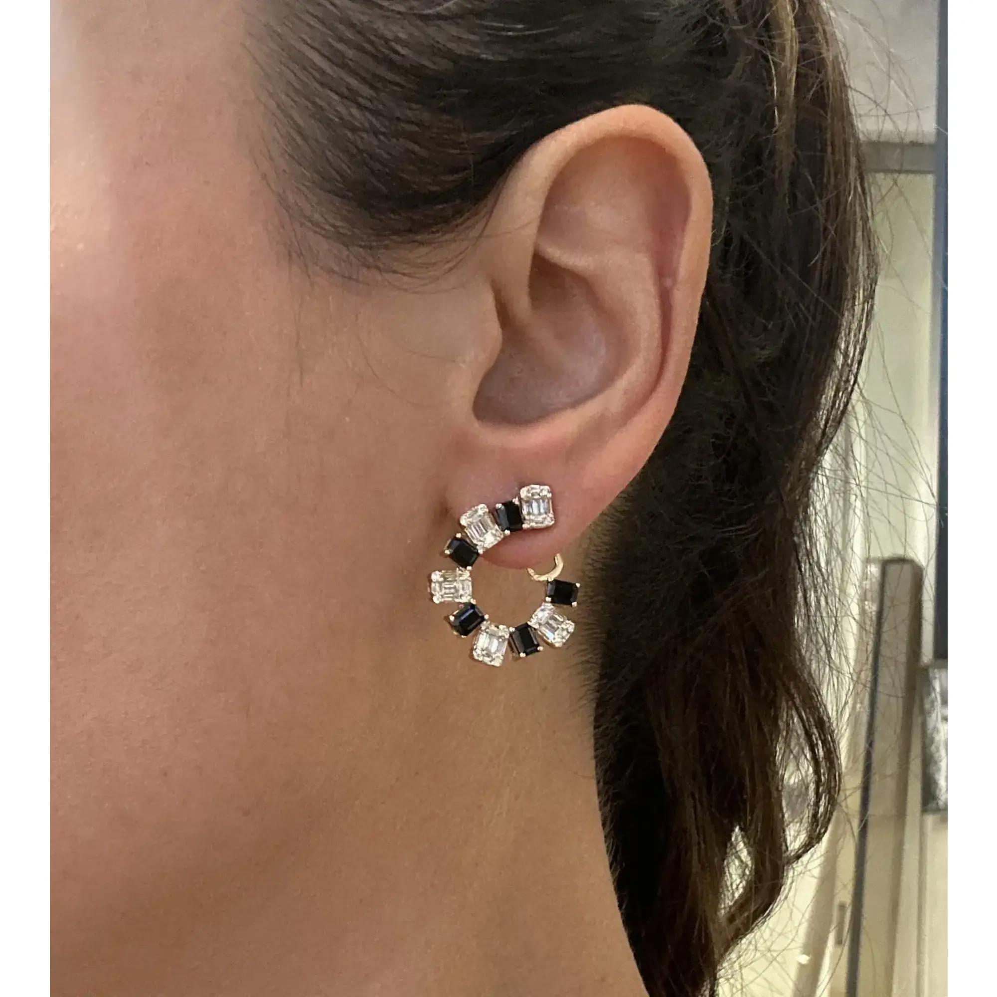 Elevate your attire with these dazzling hoop earrings. Crafted in fine 14K yellow gold. These earrings feature prong set emerald cut black onyx weighing 2.04 carats with baguette and round cut diamonds weighing 1.20 carats. Diamond quality: color