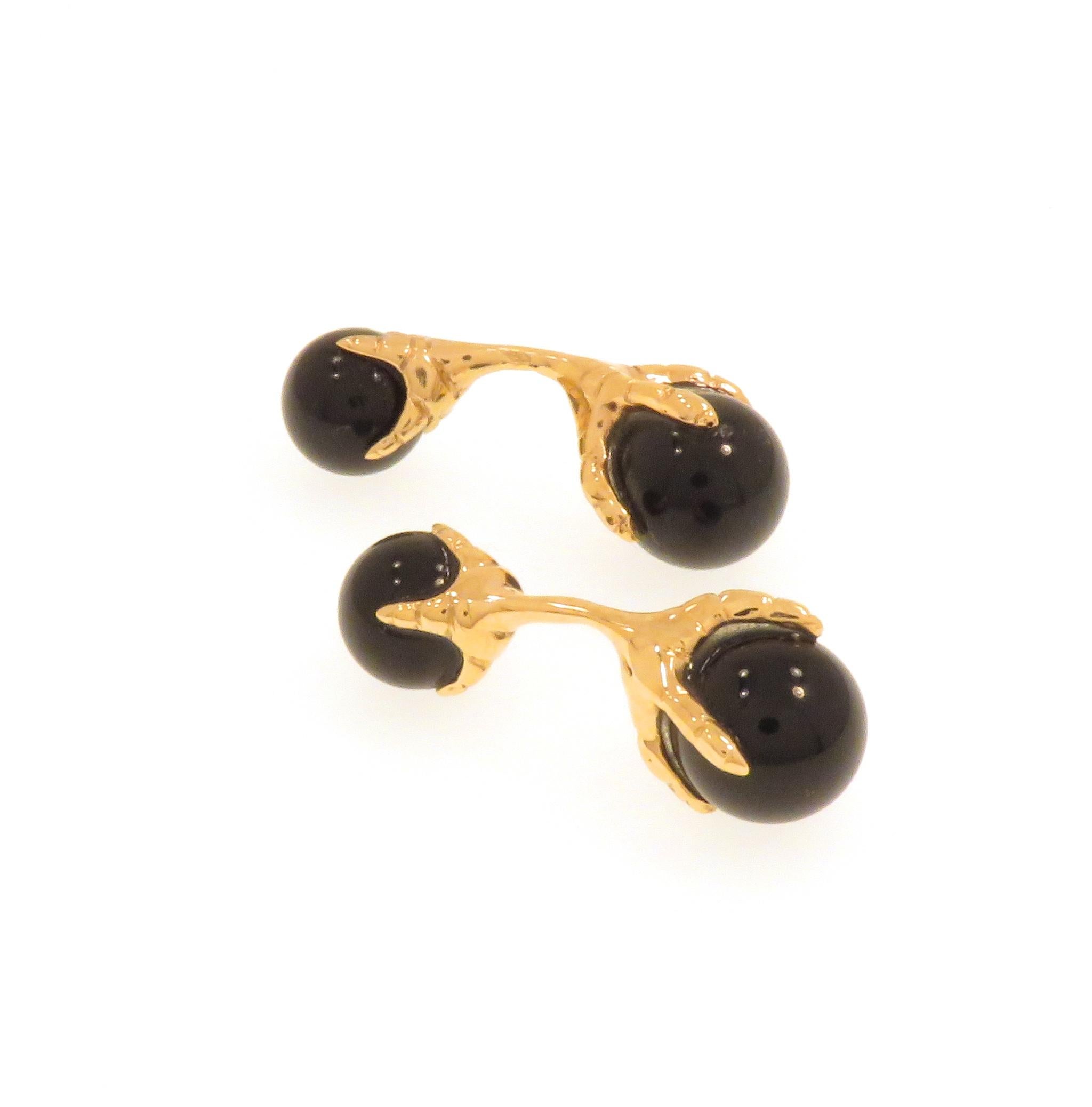 Elegant cufflinks handcrafted in 9k rose gold featuring eagle talons grabbing smooth onyx beads. The size of the bigger beads is 12 millimeters / 0.472 inches and of the smaller ones is 10 millimeters / 0.393 inches.  These cufflinks are handcrafted
