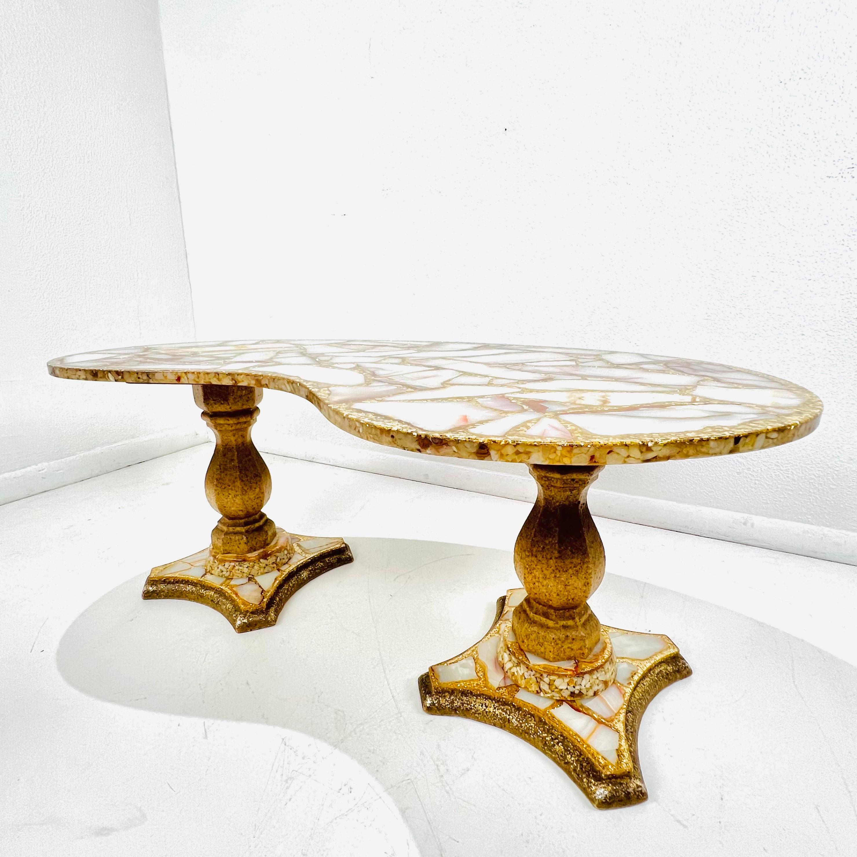 Designed by famous Mexican artist Arturo Pani (1915-1981), this rare vintage kidney shaped coffee table features cross sections of cream and copper colored onyx stone floating in a sea of gold leaf glitter and abalone shells cast in resin. Crafted