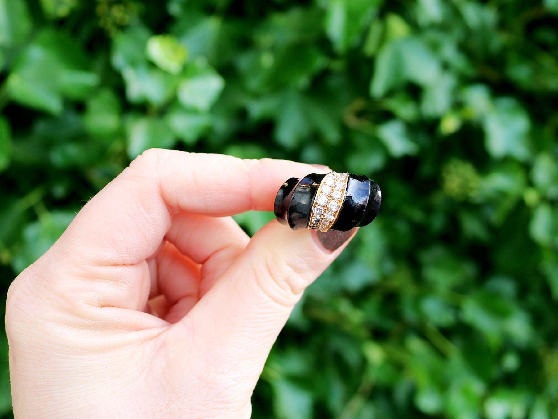 A stunning, fine and impressive antique black onyx and 1.06 carat diamond (total), 18 karat yellow gold cocktail ring; part of our diverse antique jewelry and estate jewelry collections.

This fine and impressive vintage cocktail ring has been