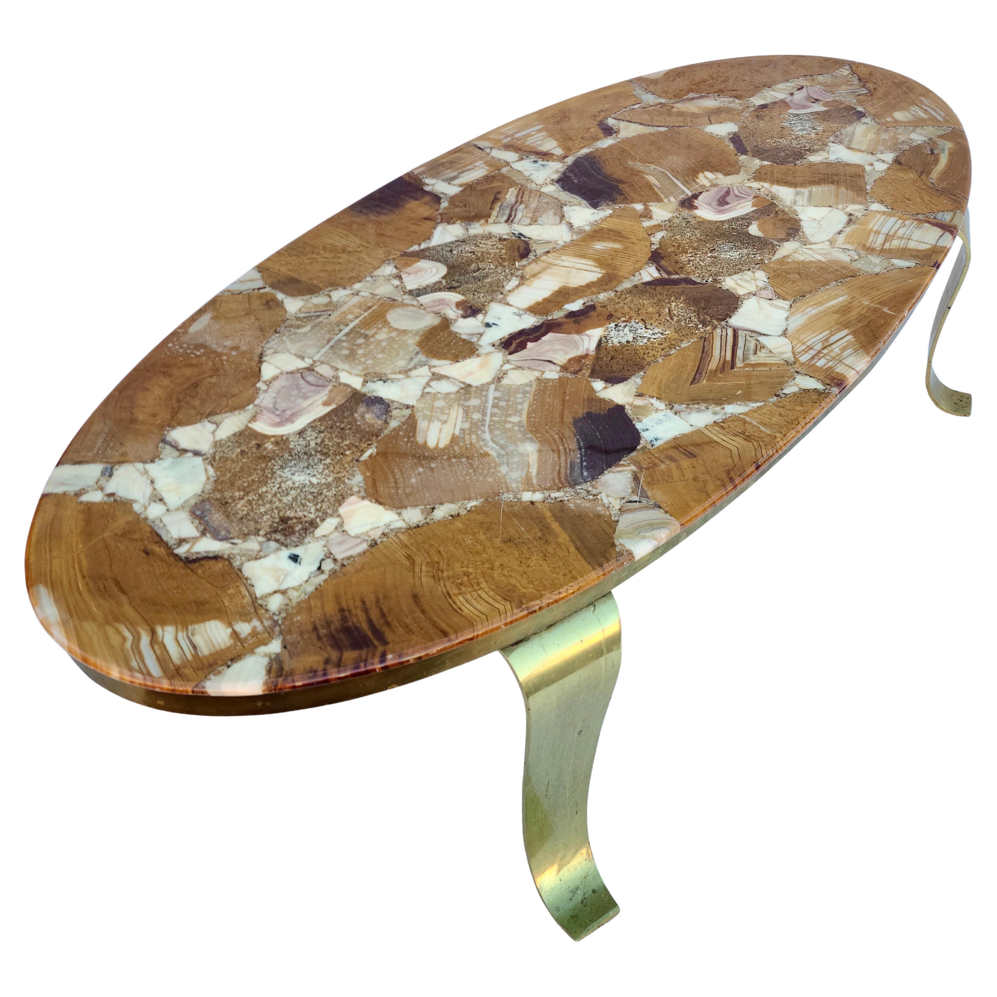 Please feel free to reach out for accurate shipping to your location.

Onyx and Brass Oval Coffee table by Muller Brothers.