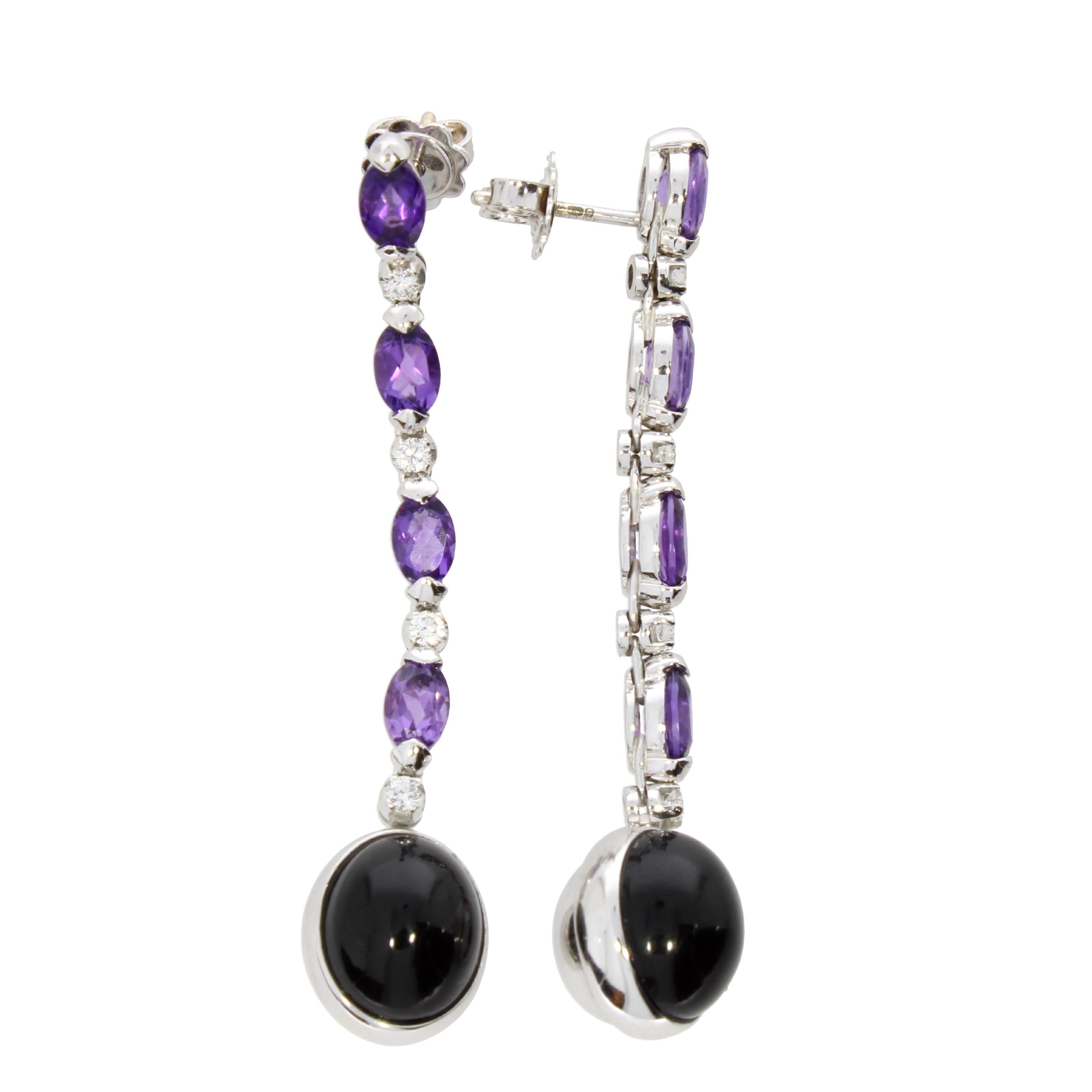 A captivating pair of rotating black onyx pendants delicately suspended on an elegant arrangement of oval cut amethysts and brilliant cut diamonds.

The Earrings are simply elegant and wearable all day long with a hight neck jumper or a white shirt