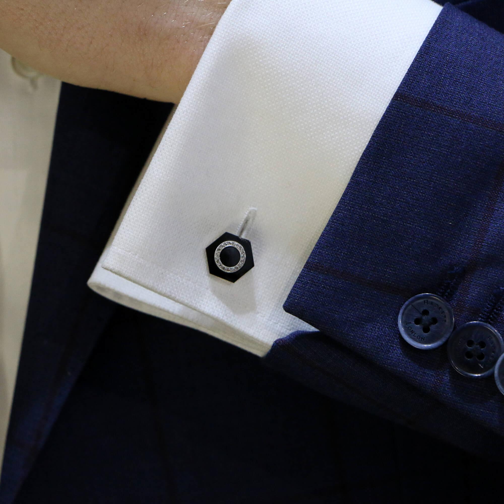 A pair of 1920's Art Deco  French onyx and gold cufflinks. 
Each cufflink is comprised of a hexagonal cut panel of onyx set with nineteen eight cut diamonds.  The contrast between the black onyx and white sparkly diamonds is striking.  These would