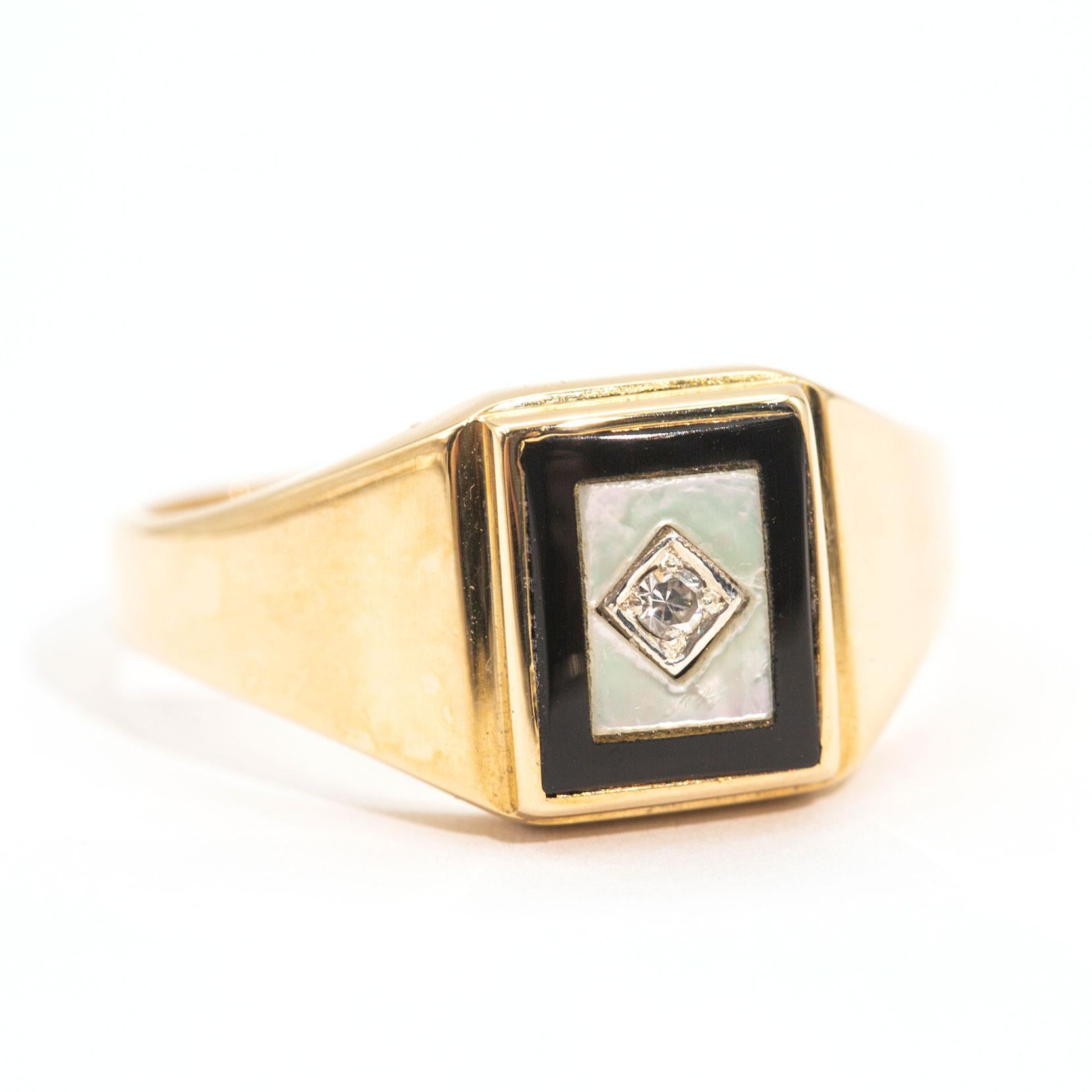 Forged in 9 carat yellow gold this handsome vintage mens signet ring features a mother of pearl and an onyx top, finely finished with round brilliant cut diamond in the centre. We have named this dapper ring the Peterson Ring.  The Peterson ring is