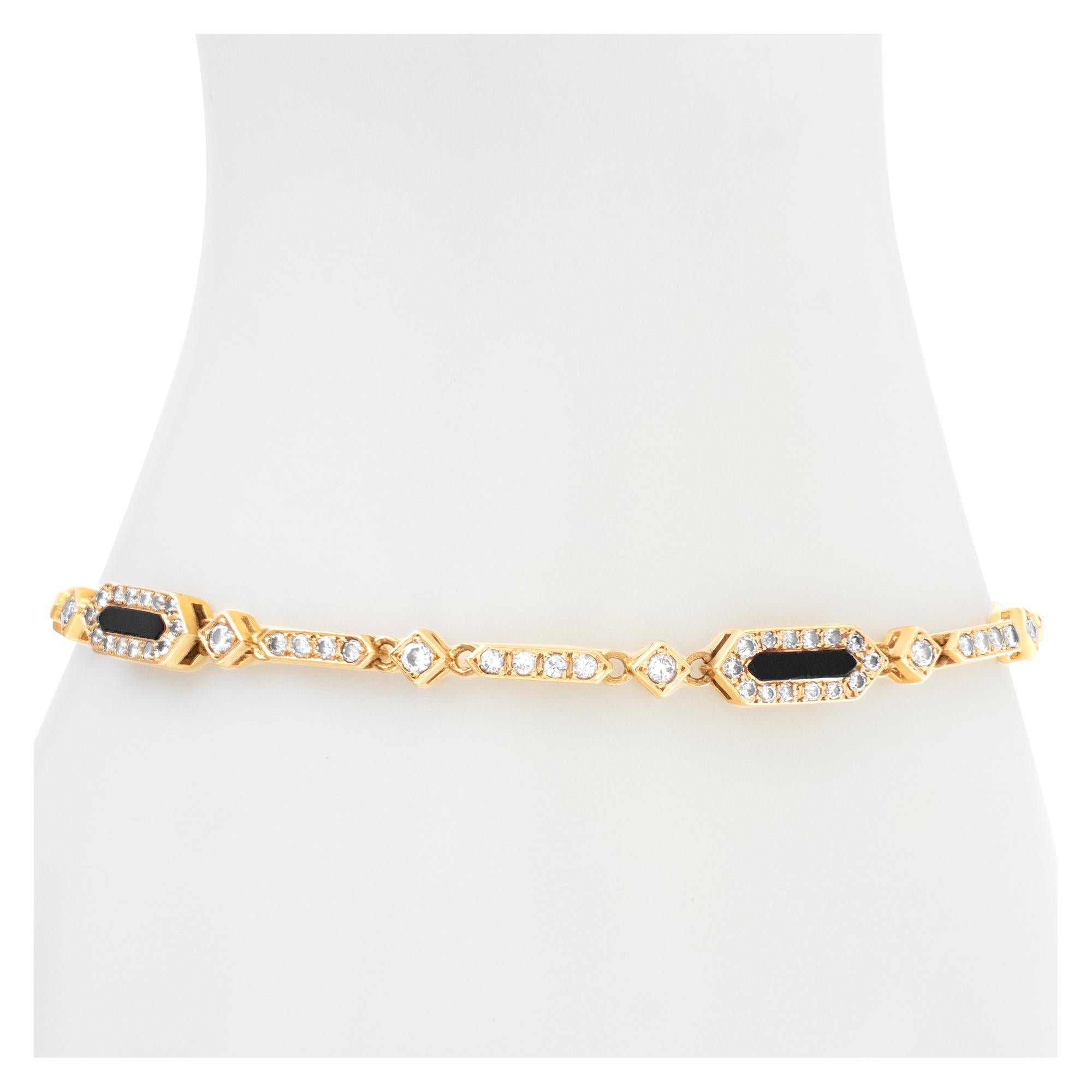Elegant onyx and diamond bracelet in 18k gold, with approximately 1.50 carat round brlliant cut diamonds, estimate: G-H color, VS clarity. Length 7.25 inches with security chain.
