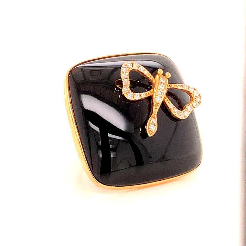 This uniquely designed cocktail ring features a stunning cushion cut black Onyx with an elegantly crafted Round Brilliant Diamond and 18K Yellow Gold dragonfly perched on it, with the Onyx being set in 18K yellow gold. 

The contrast between the