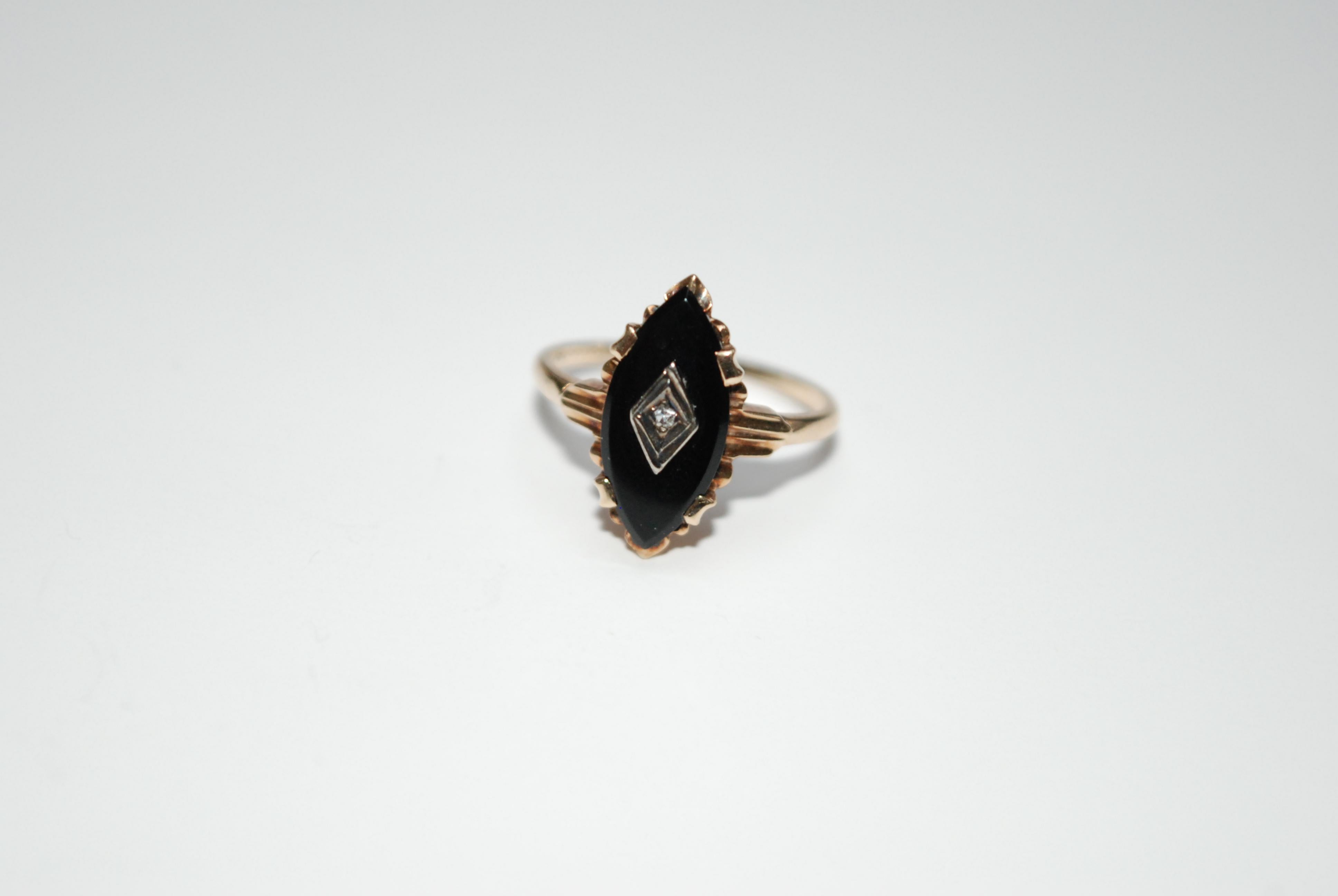 Onyx and Diamond Marquise ring set in estimated 9ct gold with silver detailing around the diamond. The shoulders and setting around the onyx is ornately sculpted in an art Deco style.


Weight: 2g

Size: US ring size 5.5

Hallmarks: none
