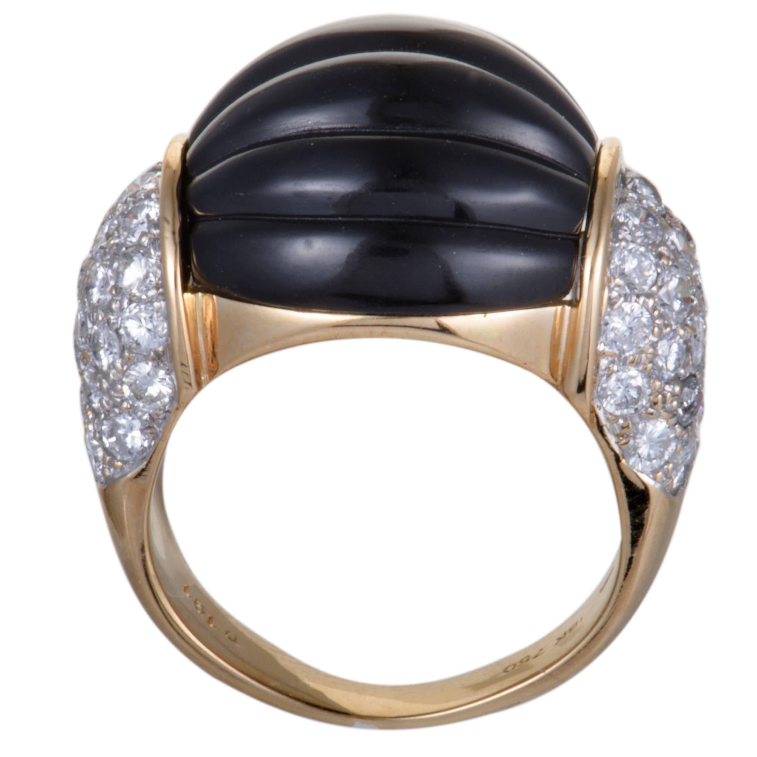Beautifully crafted in shimmering 18K yellow gold, this gorgeous ring is an exceptionally attractive item. The exemplary ring is embellished in 1.19ct of spectacular dazzling diamonds with a bold black onyx on top that makes the piece absolutely