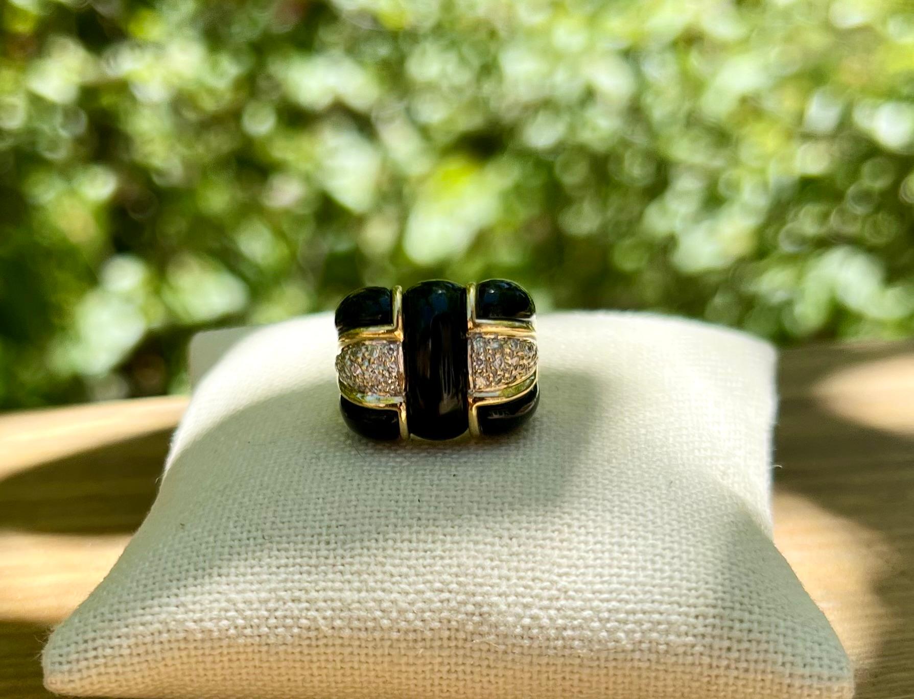 One 18 karat yellow gold (stamped 18K) custom carved onyx and diamond ring, set with thirty brilliant-cut diamonds, approximately 0.20 carat total weight with matching I/J color and SI1 clarity.  The ring is a finger size 8.

*Center stone is a bit