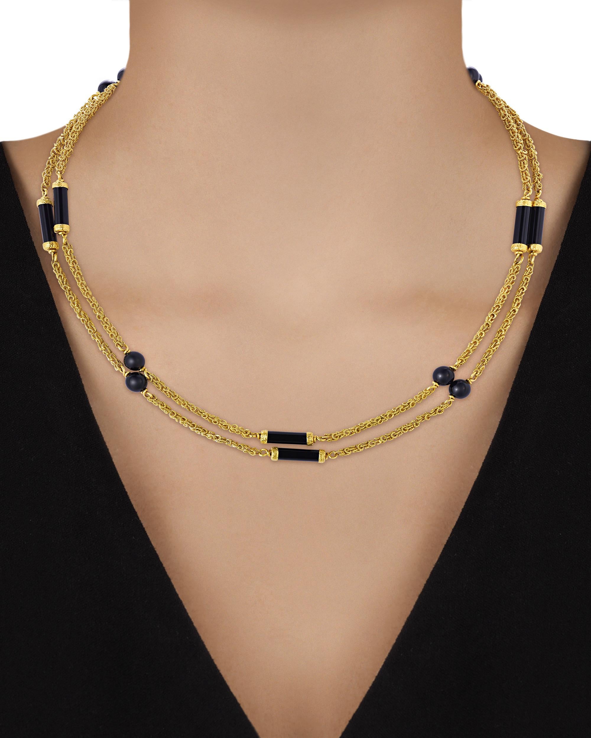 Striking and refined, this necklace from esteemed French jeweler Boucheron is crafted from 18K yellow gold and onyx. Spherical onyx beads alternate with elegant onyx rondels along a lustrous 18K gold chain, creating a unique and sophisticated look.