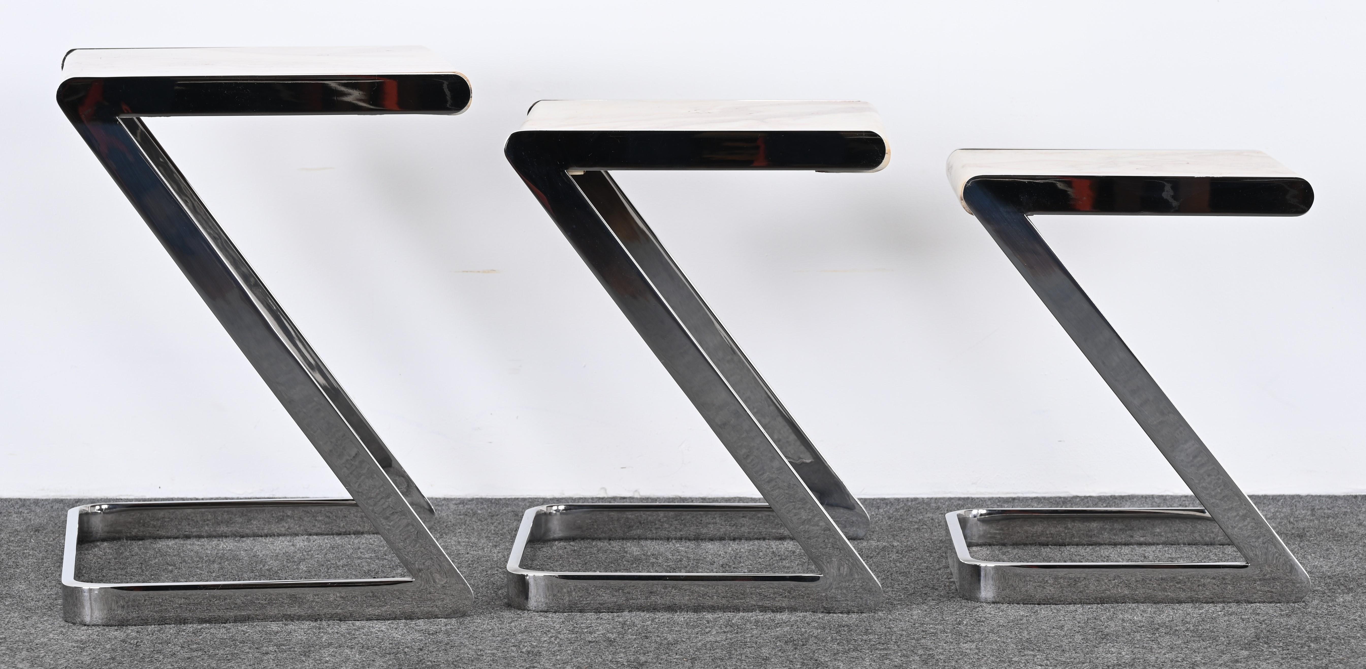 A gorgeous set of three stainless steel and onyx nesting tables by Brueton. This aesthetically pleasing set of side tables is very functional. This set came out of a high-end executive office in Pennsylvania customized and made in the 80s. Layer