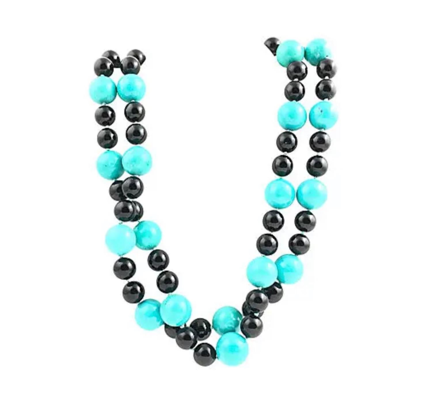 38” Long strand of 16mm reconstituted turquoise and 11.5mm onyx beads. Hand-strung with knots in between each bead. No clasp.
