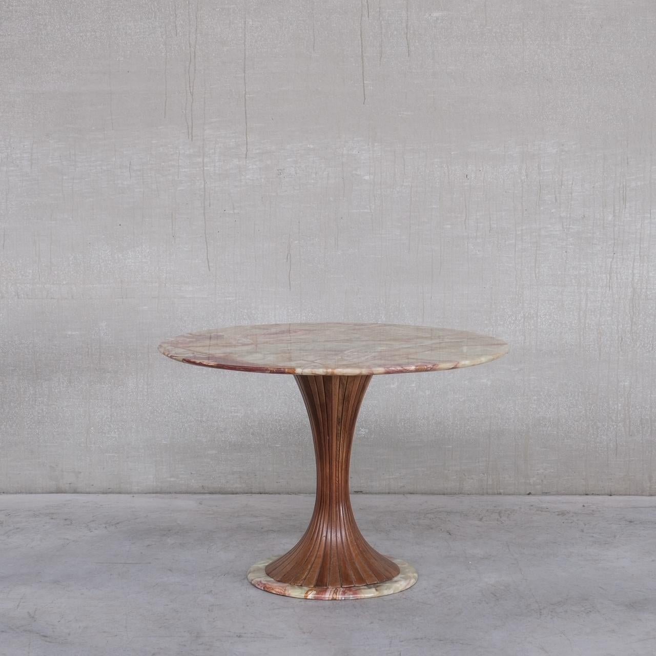 An Onyx and Wood, Italian dining or centre table. 

Italy, c1940s. 

Attributed to Vittorio Dassin. 

Solid onyx top and base, with a an elegant mahogany central pedestal. 

Remains in good condition, some scuffs and occasional scratch to