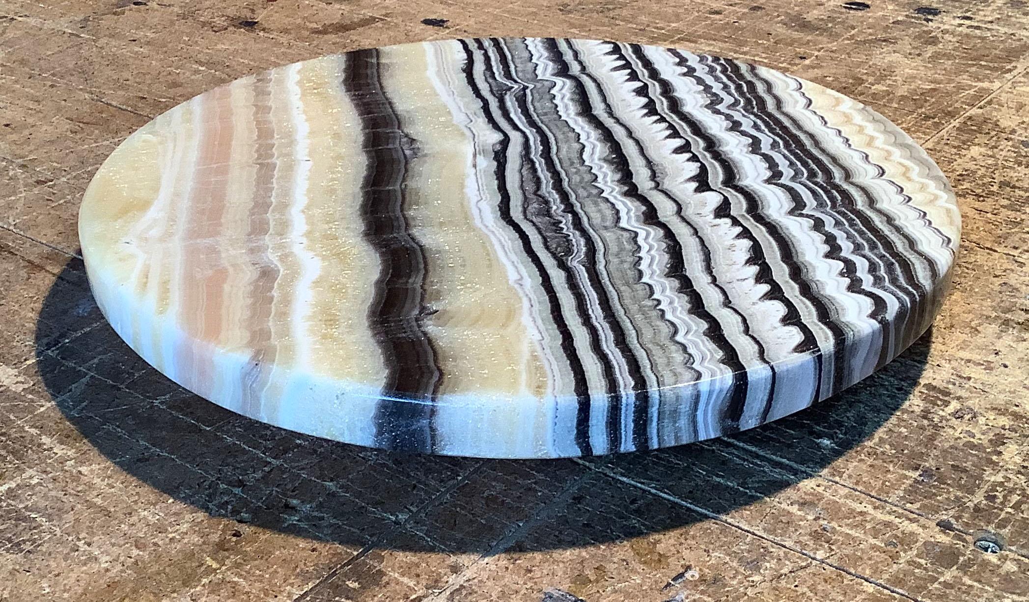 Lazy Susan carved from onyx stone with an unusual pattern of alternating black and white parallel lines.

