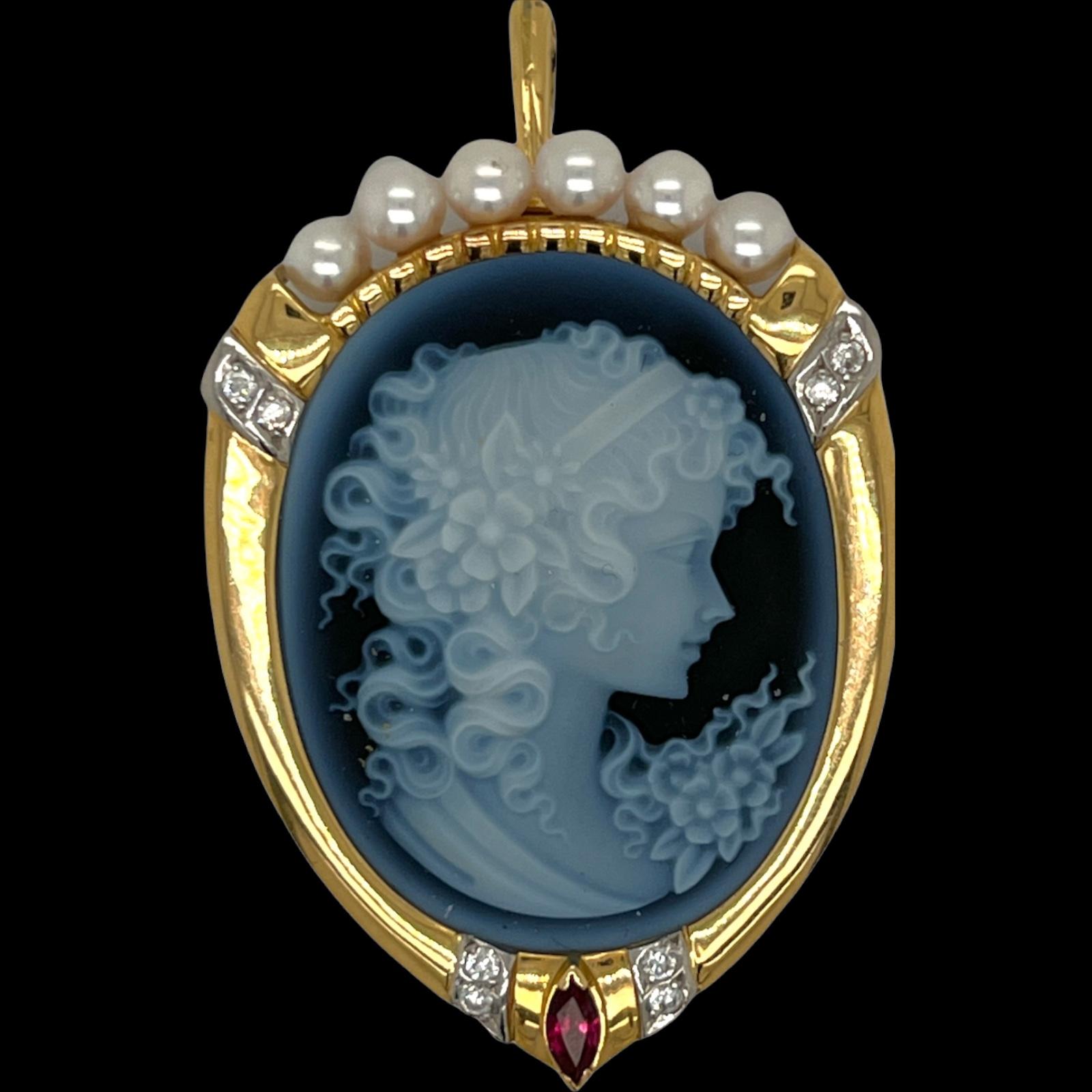 Beautiful carved cameo pendant and pin fashioned in 18 karat yellow gold and platinum. The oval onyx carved cameo is surrounded by 8 round brilliant cut diamonds weighing approximately .15 carat total weight and graded G-H/VS. The pendant is also