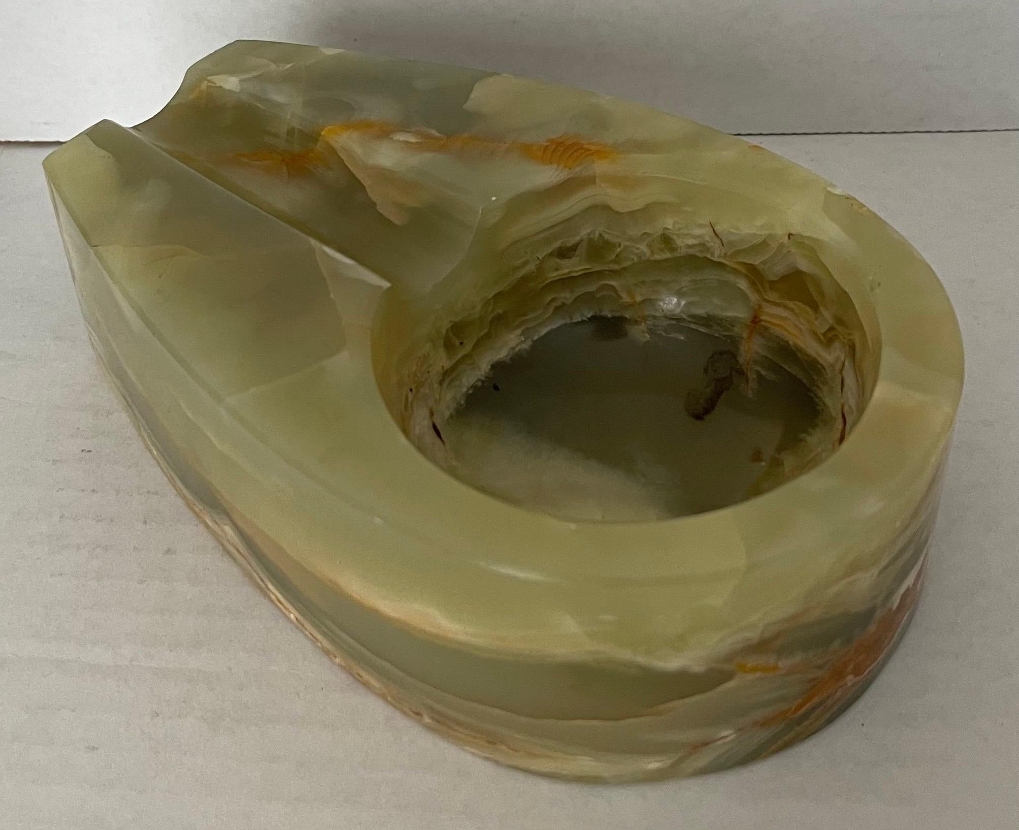 1970s pale green onyx cigar ashtray. Heavy, well made design featuring a richly veined piece of carved onyx. No makers mark or signature. 
No visible signs of wear or use.