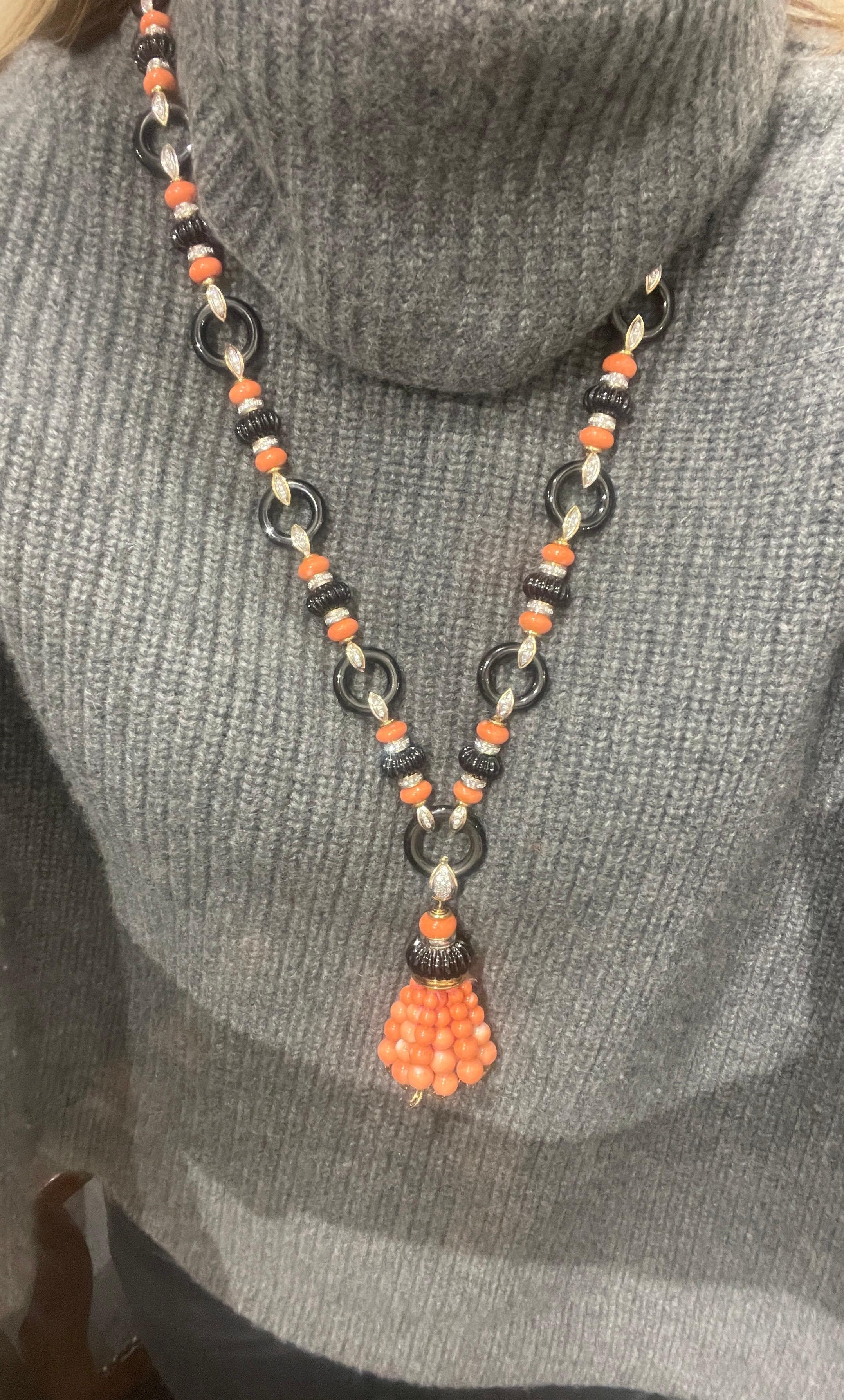 Stunning one of a kind onyx coral and diamond necklace with removable tassel. Accented with approximately 5 cttw of G/VS diamonds in 14kt yellow gold. This is the perfect show stopper necklace for all occasions.