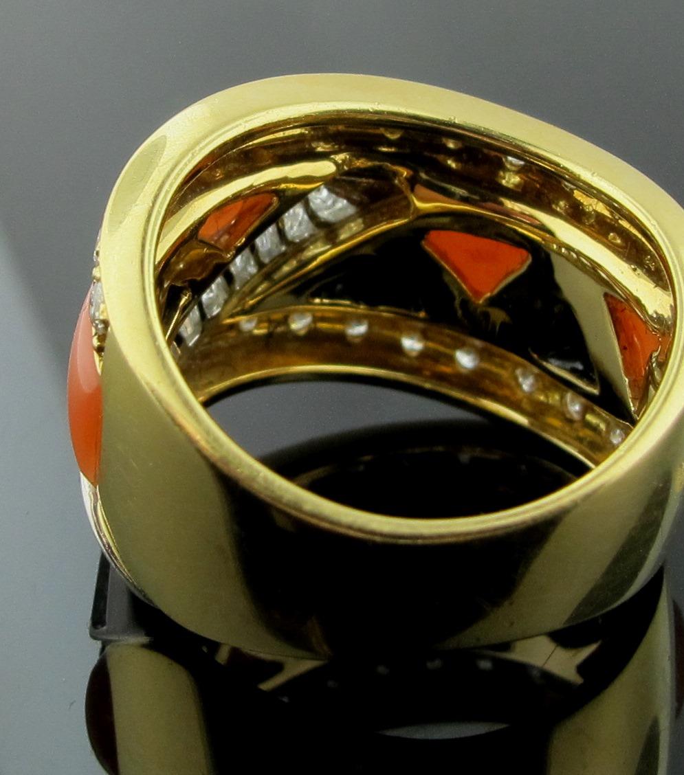 L'onyx et le corail sont sertis dans de l'or jaune 18 carats avec 23 diamants ronds de taille brillant et 10 diamants baguettes pour un poids total de diamants de 0,98 carats.  La taille de la bague est de 6.